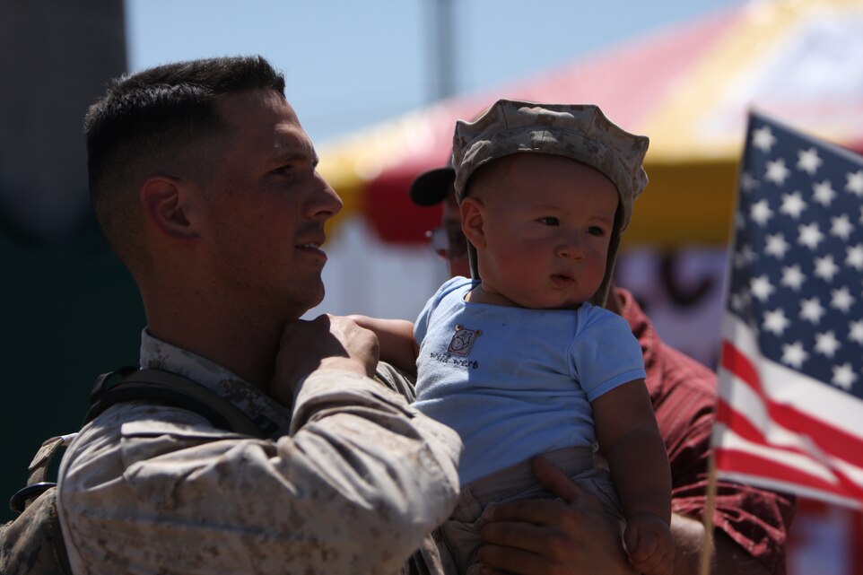Capt. Justin Sharpe, the executive officer of Company C, 3rd Light Armored Reconnaissance Battalion, holds his 8-month-old son, Julian, after returning home to the Combat Center's Victory Field Sept. 8. Sharpe, a native of Mabton, Wash., was deployed to Iraq's Al Anbar Province for the past seven months in support of Operation Iraqi Freedom.