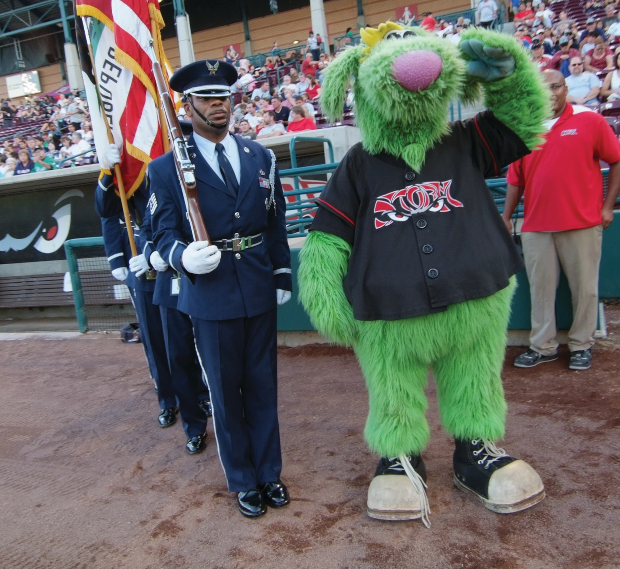 “Thunder,” the Lake Elsinore Storm mascot, salutes as the March Field Honor Guard prepares to present the colors at homebase on the baseball diamond. (U.S. Air Force photos by Tech. Sgt. Joe Zuccaro)