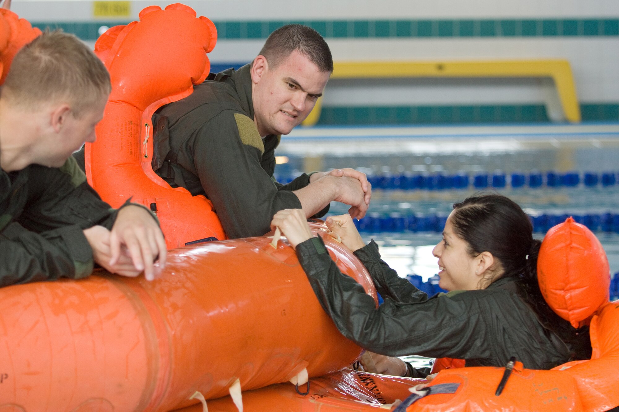YOKOTA AIR BASE, Japan -- Staff Sgt. Wilma Alvarez, 36th Airlift Squadron loadmaster, climbs into a 20-man life raft during during water survival refresher training recently at the Natatorium Indoor Pool. Survival, evasion, resistance, and escape technicians teach the course to aircrew members at least once every three years. The training is especially important for Yokota aircrews, who routinely fly long distances over large bodies of water in the Pacific Rim. (U.S. Air Force photo/Osakabe Yasuo) 

