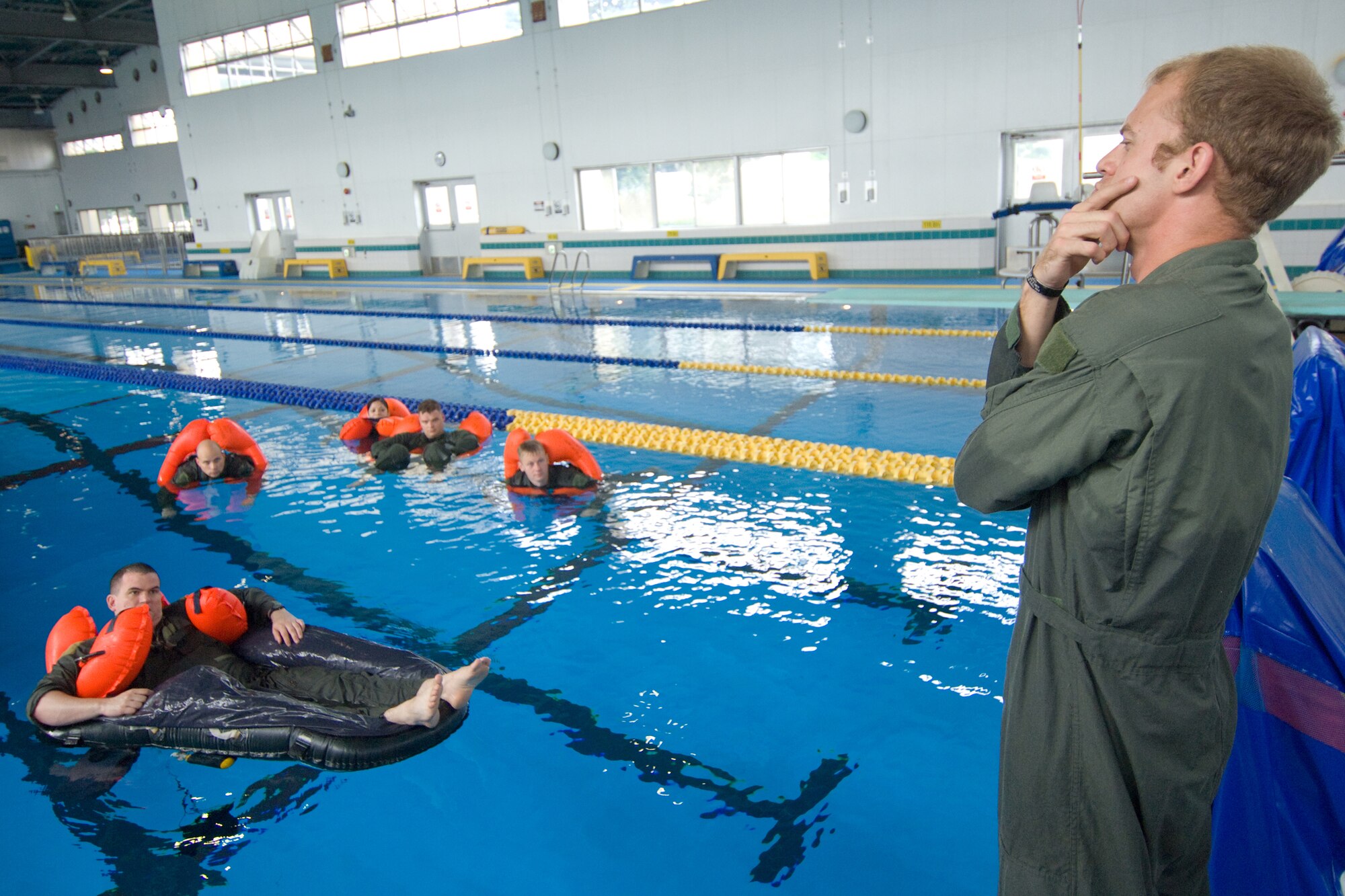 YOKOTA AIR BASE, Japan -- Staff Sgt. Steven Raethel, 374th Operations Support Squadron Survival, Evasion, Resistance and Escape specialist, teaches water survival refresher training recently at the Natatorium Indoor Pool. Survival, evasion, resistance and escape technicians teach the course to aircrew members at least once every three years. The training is especially important for Yokota aircrews, who routinely fly long distances over large bodies of water in the Pacific Rim. (U.S. Air Force photo/Osakabe Yasuo) 



