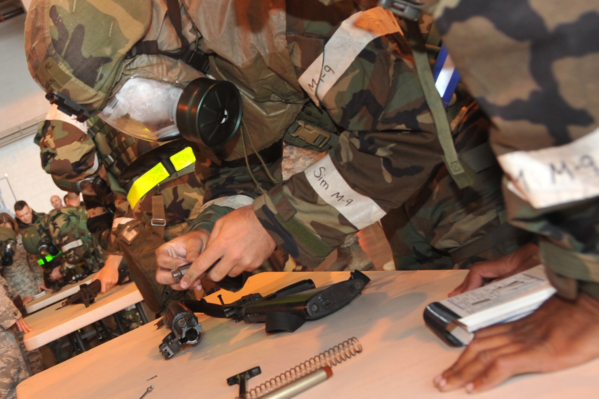 OFFUTT AIR FORCE BASE, Neb. - Team members from the 55th Maintenance Group reassemble an M-16 at the Bennie Davis Maintenance Facility, Sept. 3, 2009. Airmen gathered for a commander's call followed by a series of competitive events to prepare for the Operation Readiness Inspection Sept. 10 - 16. U.S. Air Force photo by Jeff W. Gates.
