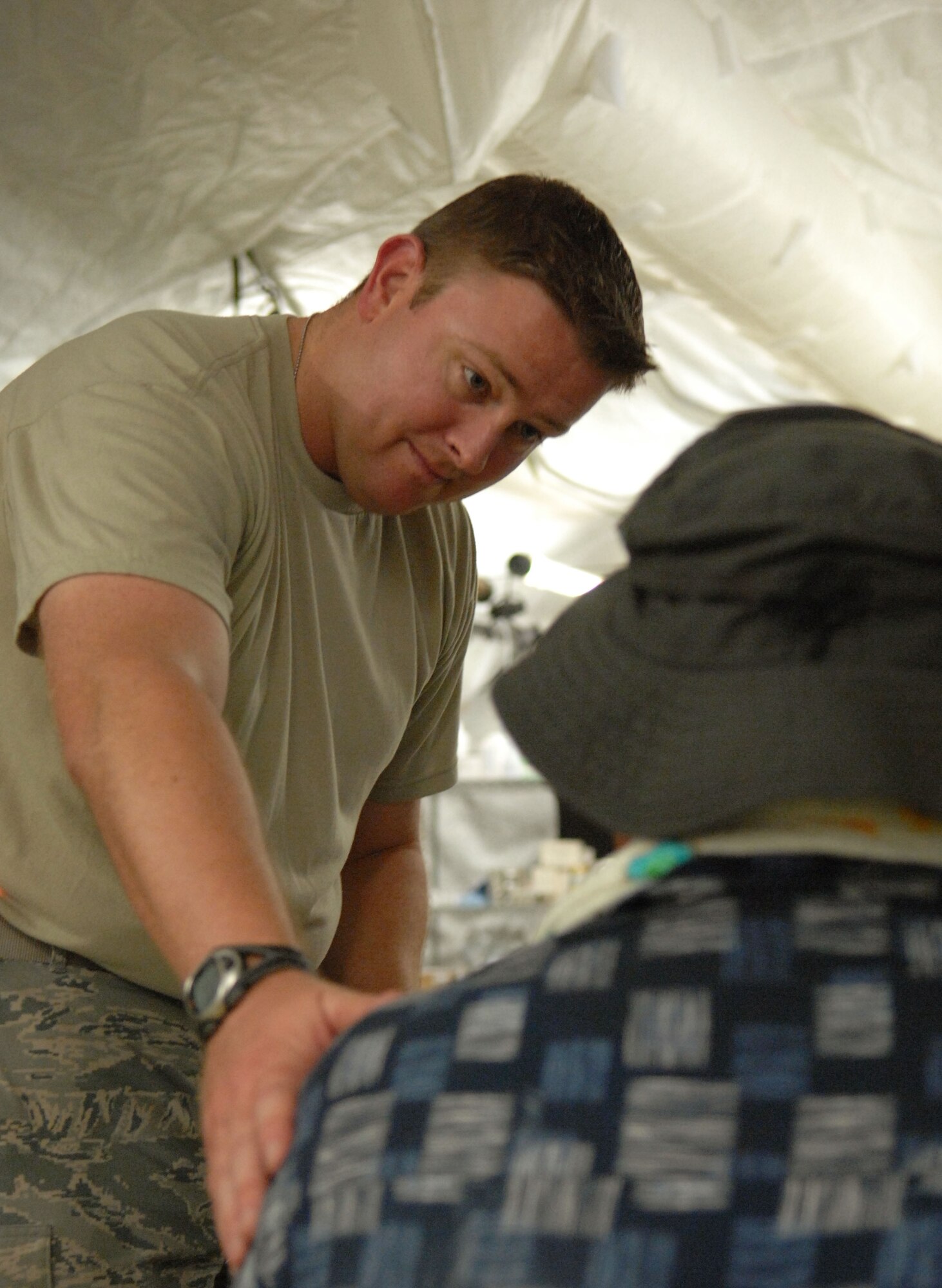 U.S. Air Force Capt. (Dr.) Christopher Lindshield, from the 374th Medical Group at Yokota Air Base, Japan, speaks to a patient during the Humanitarian Assistance Rapid Response Team (HARRT) validation exercise Sept. 4, 2009, on Chuuk, in the Federated States of Micronesia.  The HARRT is the Air Force's new expeditionary medical capability designed to deploy within 24-hours of notice during disaster relief operations.  Based at Andersen Air Force Base, Guam, the team provides basic medical care and public health assistance to 350 to 500 patients per day.  (U.S. Air Force photo by Capt. Andrew Hoskinson)
