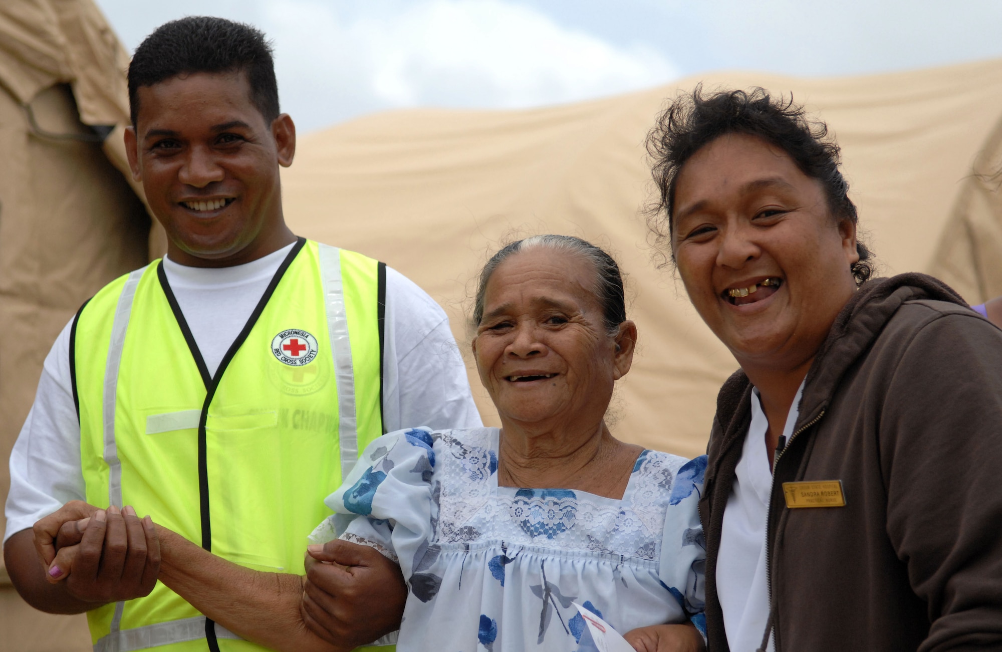A Chuukese woman is escorted by two volunteers after receiving treatment from the Humanitarian Assistance Rapid Response Team (HARRT) during a validation exercise Sept. 3, 2009, on Chuuk, in the Federated States of Micronesia.  The HARRT is the Air Force's new expeditionary medical capability designed to deploy within 24-hours for disaster relief operations.  Based at Andersen Air Force Base, Guam, the team provides basic medical care and public health assistance to 350-500 patients per day.  (U.S. Air Force photo by Capt. Andrew Hoskinson)