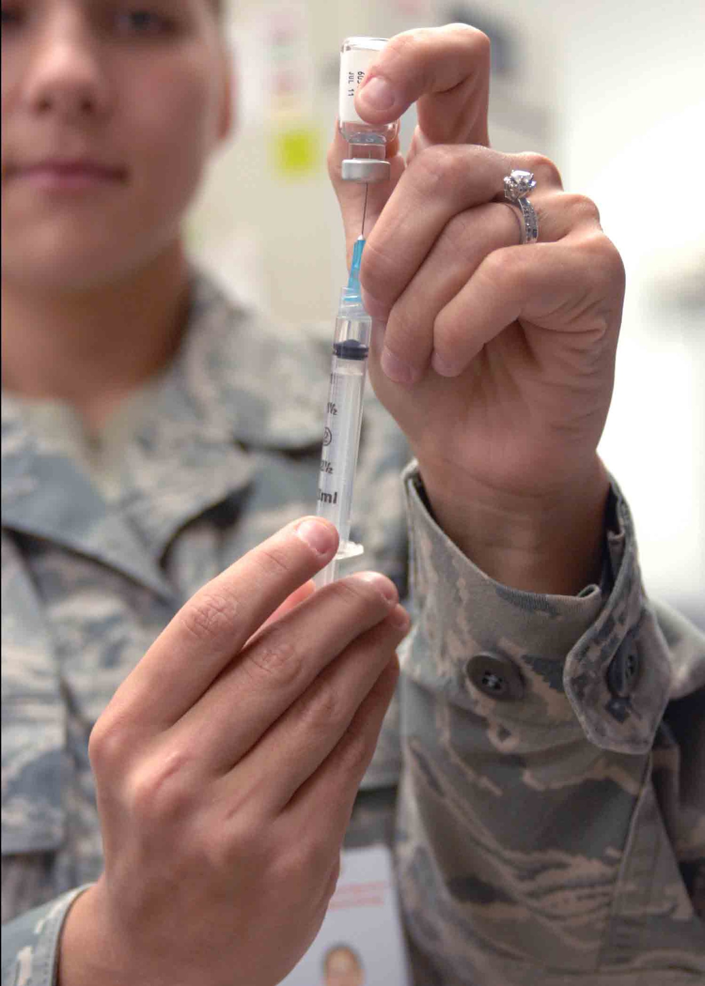 CANNON AIR FORCE BASE, N.M.-- Airman 1st Class Dena Levari, 27th Special Operations Medical Group, extracts the flu vaccination from a vial for a shot at the Clinic Sept. 8.  Squadrons can contact the clinic's appointment hotline at 784-2778 to set up a time at the end of the month when the vaccine becomes available.  (U.S. Air Force photo by Airman 1st Class James Bell)