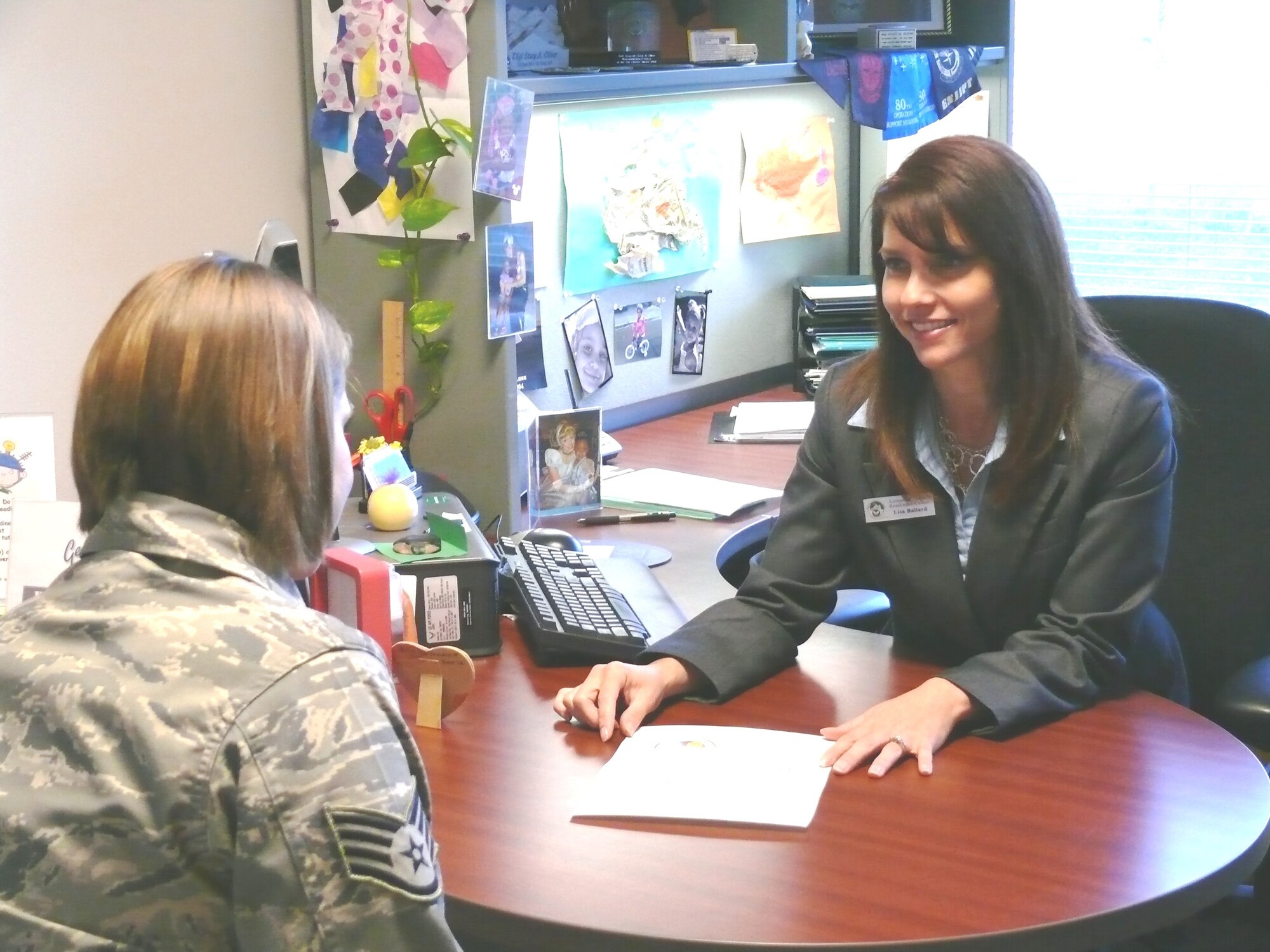 Lisa Ballard, 21st Space Wing military child education coordinator, meets with a customer at her office in the Airmen & Family Readiness Center.   The position of military child education coordinator was specifically designed to assist Airmen by enhancing the educational experience of their children. (Air Force photo)