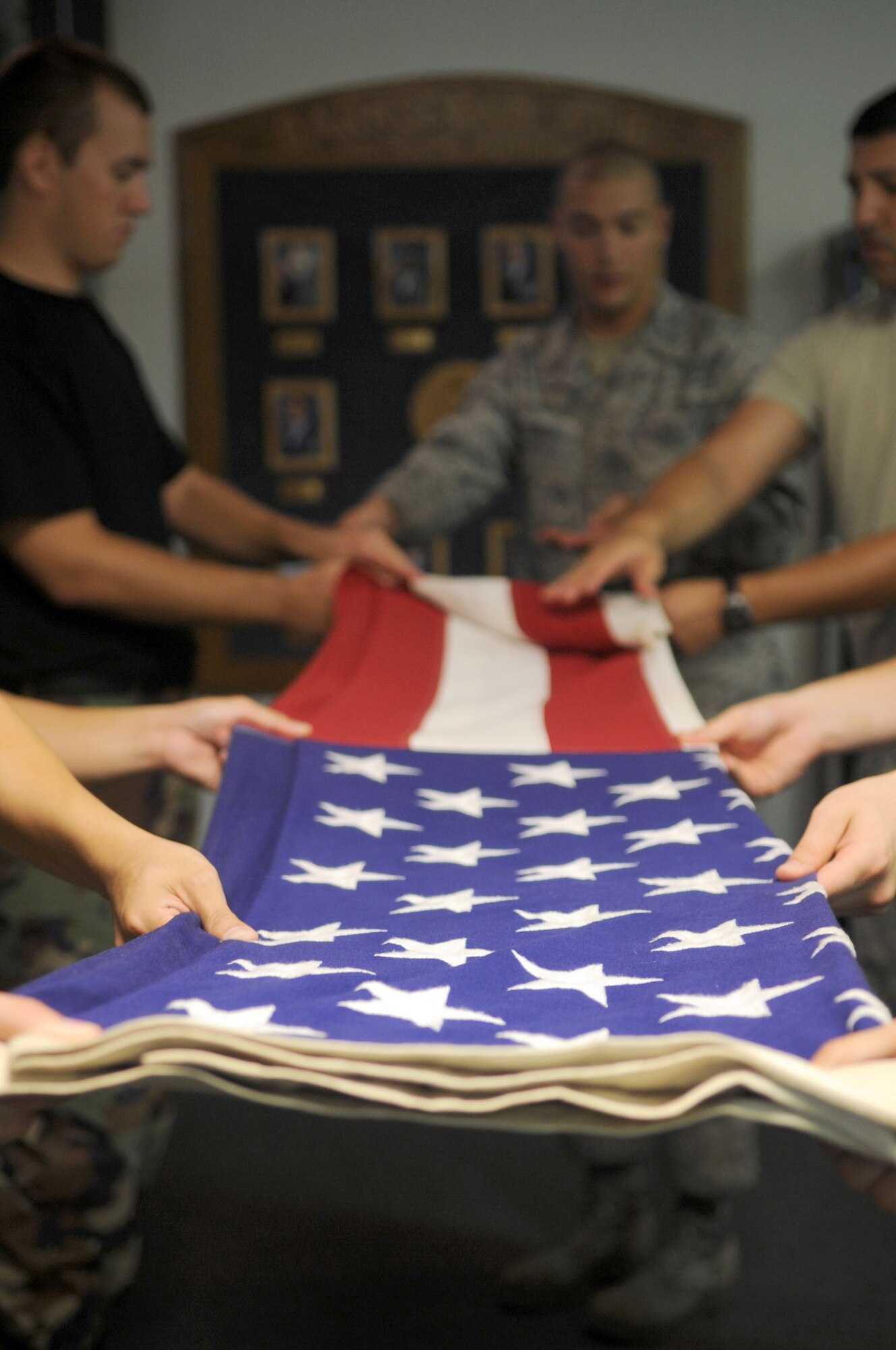 Members of Barksdale Honor Guard are instructed on how to properly fold the flag during practice with members of the Air Force Honor Guard. (U.S. Air Force photo/ Airman 1st Class Brittany Y. Bateman)