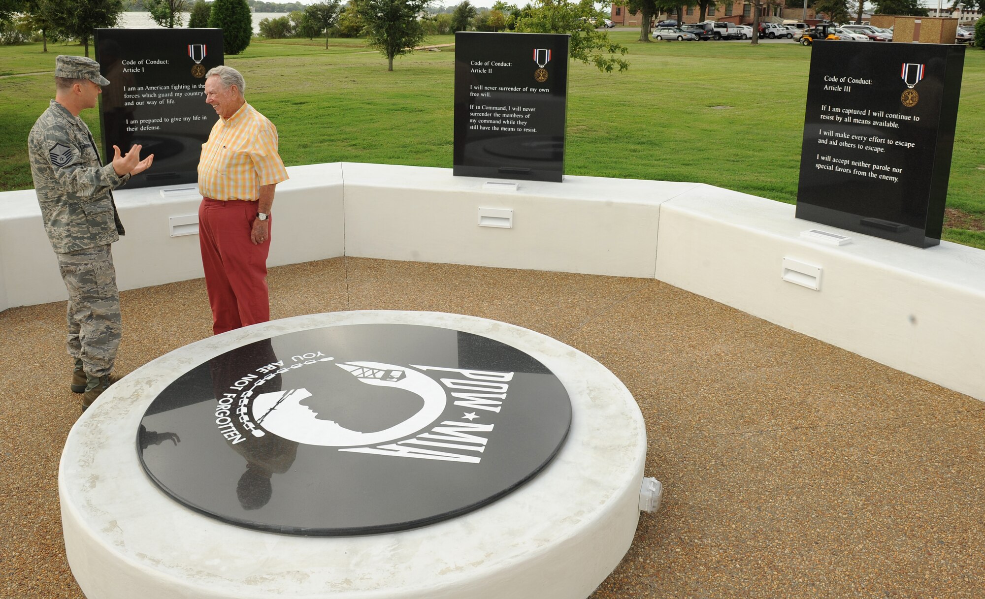 LANGLEY AIR FORCE BASE, Va. - Master Sgt. Robert Casagrande, Air Combat Command joint surveillance and target attack radar system manager, talks to retired Col. Frederick Crow, an F-4C pilot and prisoner-of-war during the Vietnam War, at the newly constructed POW/MIA Memorial here Sept. 3. (U.S. Air Force photo/Airman 1st Class Gul Crockett)