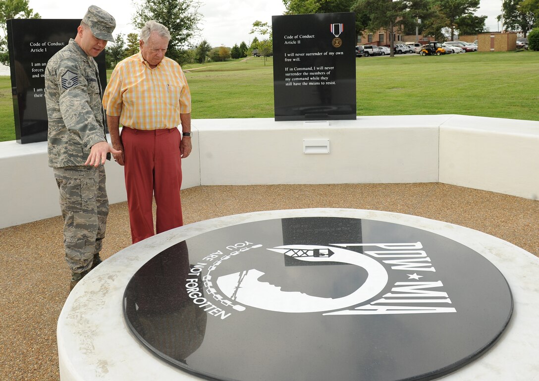 LANGLEY AIR FORCE BASE, Va. - Master Sgt. Robert Casagrande, Air Combat Command joint surveillance and target attack radar system manager, talks to retired Col. Frederick Crow, an F-4C pilot and prisoner-of-war during the Vietnam War, at the newly constructed POW/MIA Memorial here Sept. 3. (U.S. Air Force photo/Airman 1st Class Gul Crockett)