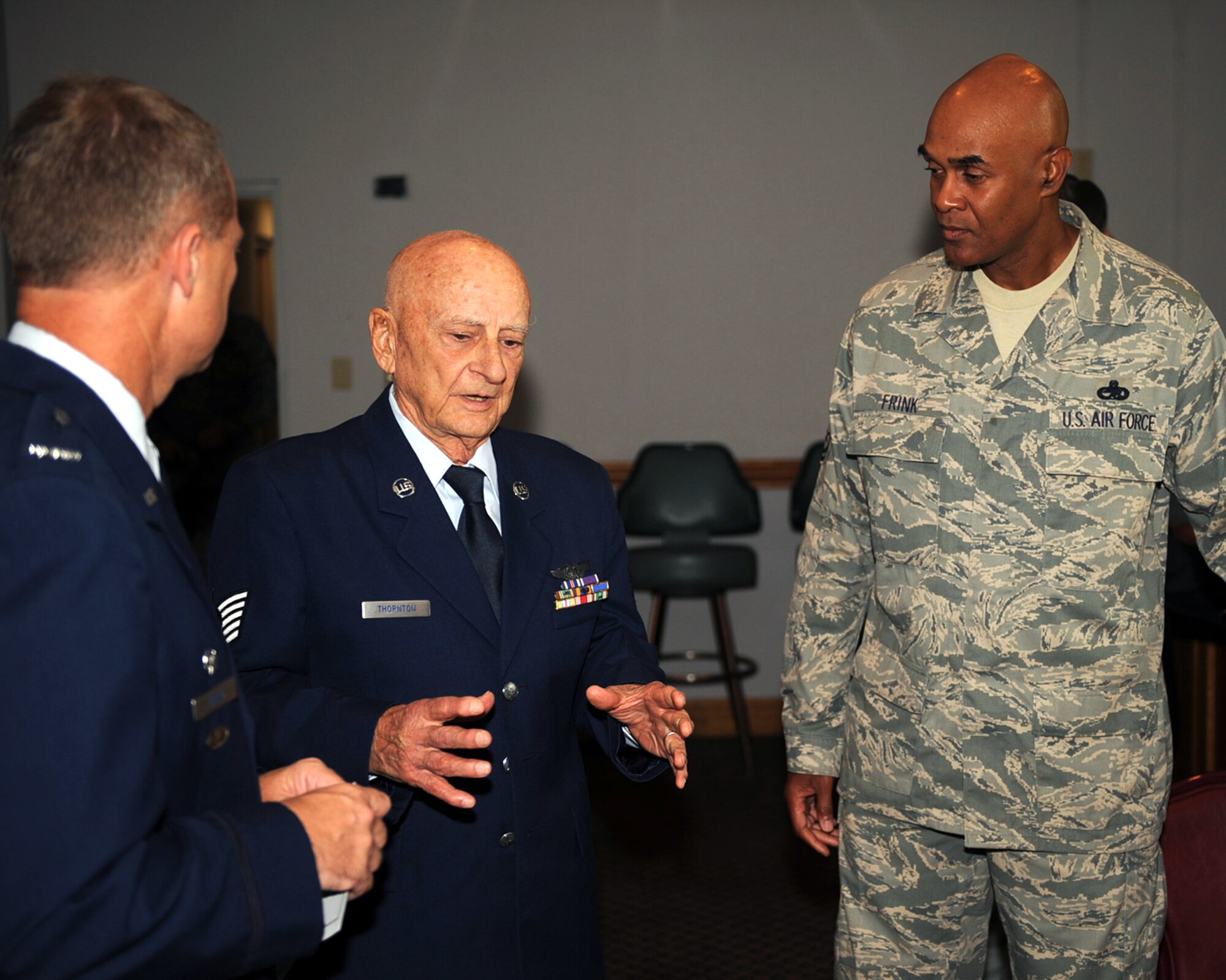 World War II veteran Tech. Sgt. Holt Thornton speaks with Col. Mark Kelly and Chief Master Sgt. Leroy Frink after a medal presentation ceremony Aug. 29, 2009 at Seymour Johnson Air Force Base, N.C. Colonel Kelly presented Mr. Thornton with five medals for his service during World War II, including The Purple Heart and Air Medal. Mr. Thornton was a B-24 Liberator aerial gunner while part of the Army Air Corps, and spent his last three months in the service here. Colonel Kelly is the 4th Fighter Wing commander. Chief Frink is the 4th FW command chief. (U.S. Air Force photo/Senior Airman Ciara Wymbs)