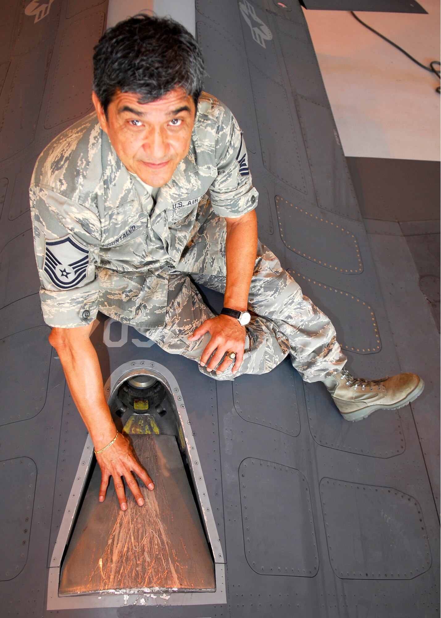 Master Sgt. Edward Montalvo of Tecumseh, Michigan, a fuels system technician assigned to the Texas Air National Guard's 149th Fighter Wing, shows an F-16 in-flight refueling door that leads to the coil induction plate at Lackland Air Force Base, Texas on Aug. 27, 2009. (U.S. Air Force photo by Senior Master Sgt. Mike Arellano)(RELEASED).