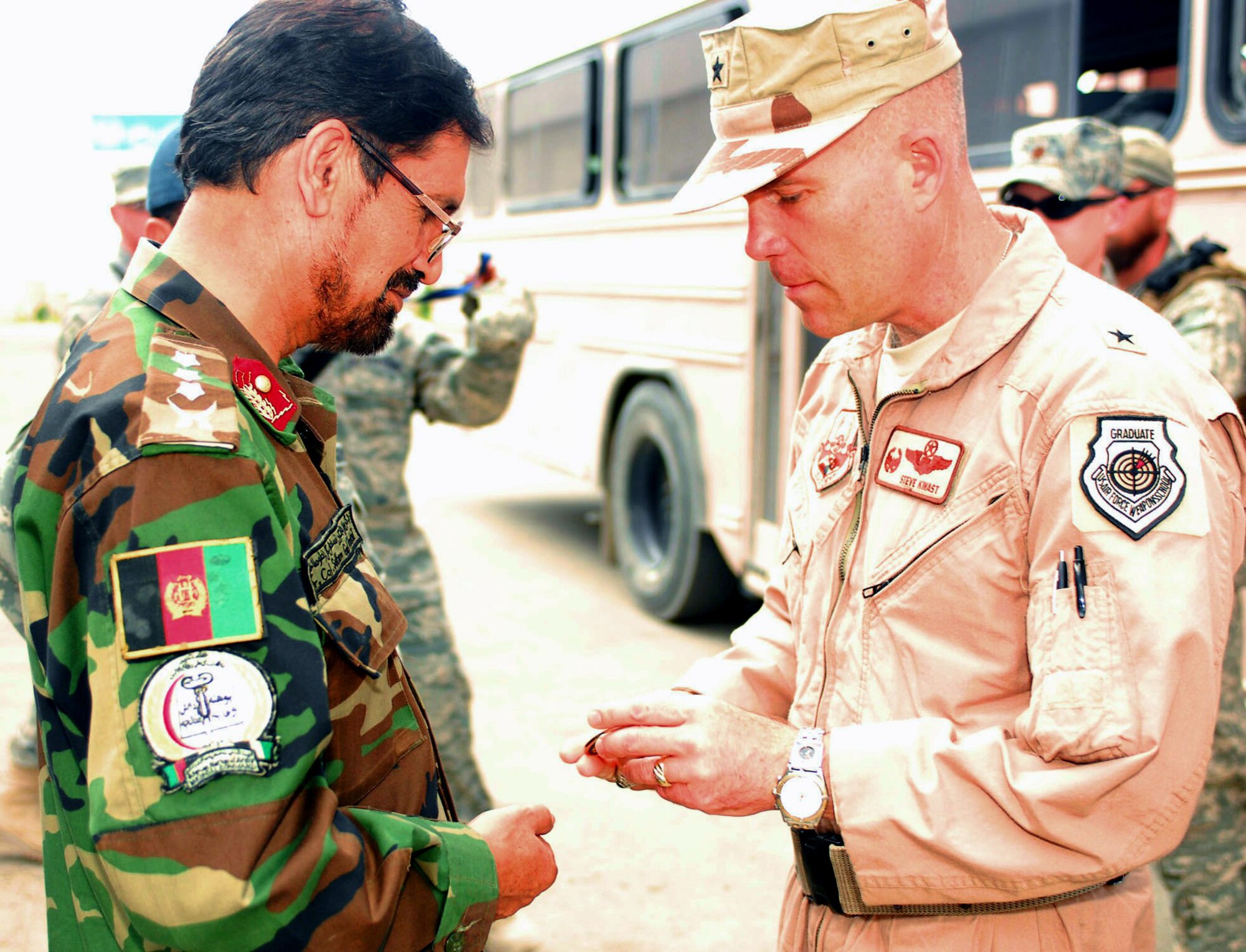 Brig. Gen. Steve Kwast presents Afghan National Army Col. (Dr.) Sultangal Totakhail a 455th Air Expeditionary Wing commander's coin during a tour of Paktia Regional Medical Hospital at Forward Operating Base Lightning, Afghanistan, Aug. 30, 2009. Airmen assigned to FOB Lightning are there as joint expeditionary tasked Airmen who work day-to-day for Army commanders while they're also assigned administratively to Air Force commanders under the 755th Air Expeditionary Group at Bagram Airfield, Afghanistan. The JET Airmen are part of the Embedded Training Team here, which mentors Afghan National Army Forces. General Kwast is the 455th Air Expeditionary Wing commander. (U.S. Air Force photo/Capt. David Faggard)