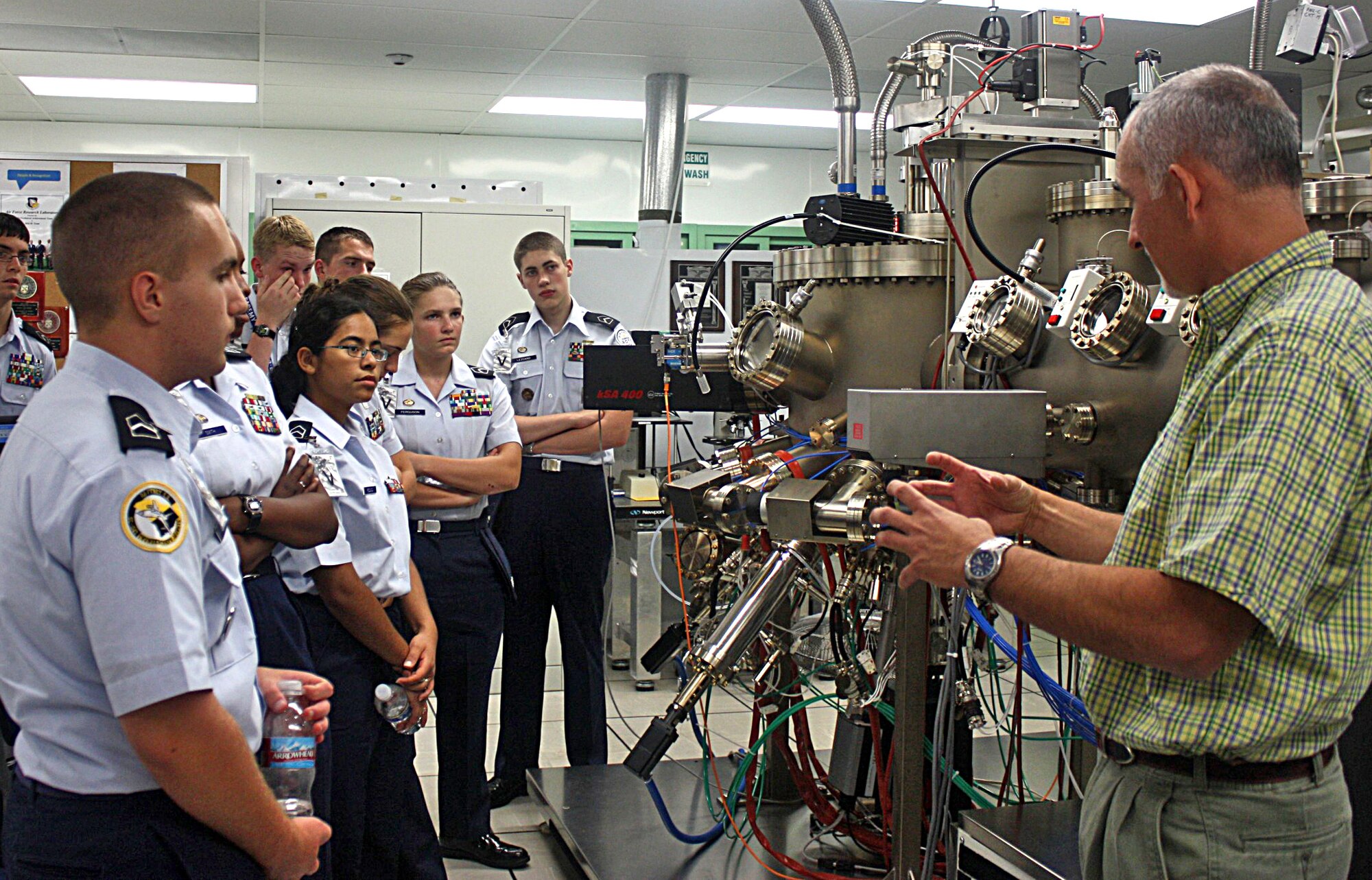 Several Junior ROTC cadets and laboratory scientist, Dr. Ron Kaspi, are pictured while touring AFRL?s Molecular Beam Epitaxy Laboratory, a state-of-the-art facility that enables in-house growth of semiconductor crystals used in building lasers.  U.S. Air Force photograph by Michele Sager