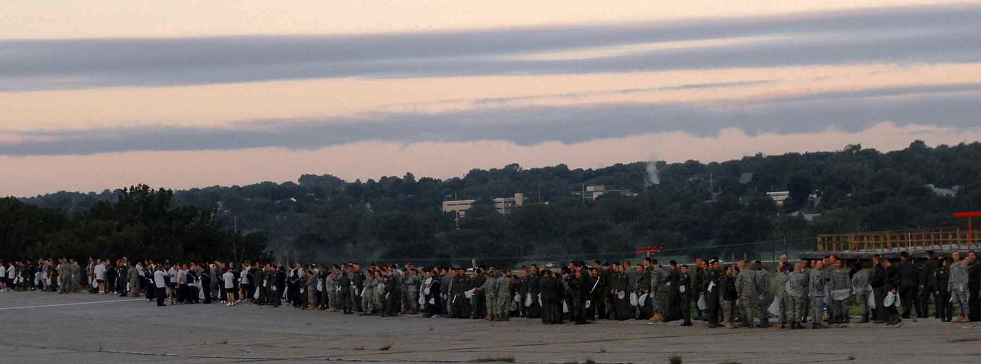 OFFUTT AIR FORCE BASE, Neb. - Offutt Airmen line up for a foreign object debris detection walk Aug. 31 on the Offutt flight line. The FOD walk took place after the 2009 "Defenders of Freedom" Open House and Air Show to ensure the safety of planes using the runway. U.S. Air Force photo by Kendra Williams.