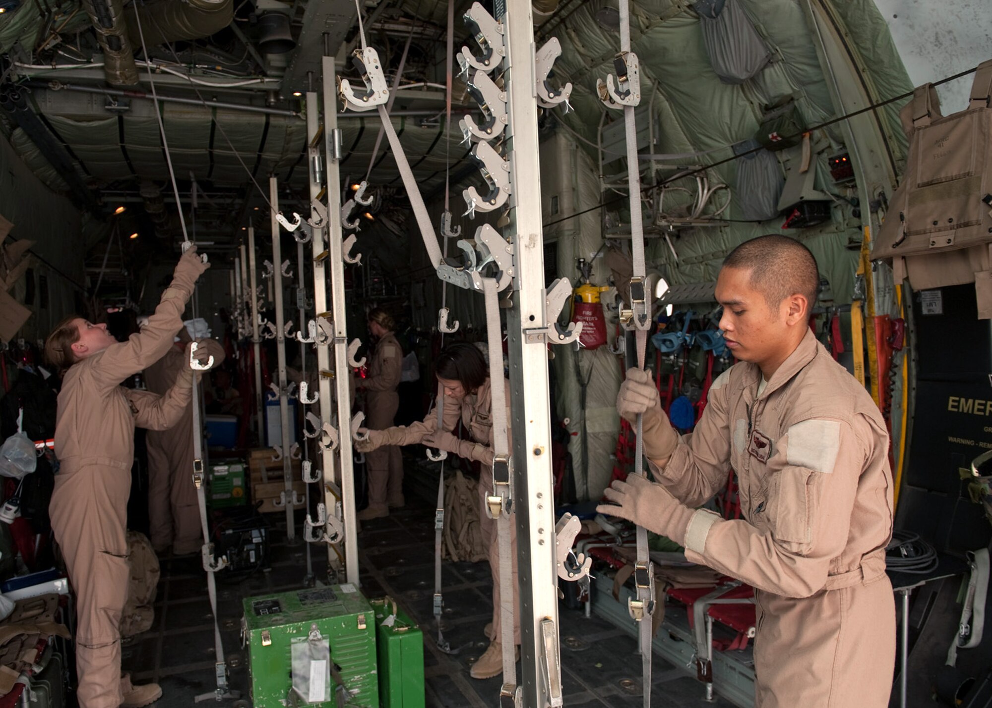 Staff Sgt. Ryan Balubar along with fellow Airmen from the 379th Expeditionary Aeromedical Evacuation Squadron prepare a C-130 Hercules to transport medical patients Aug. 15, 2009, at an air base in Southwest Asia. Sergeant Balubar is an aeromedical evacuation technician deployed from Kadena Air Base, Japan. (U.S. Air Force photo/Staff Sgt. Robert Barney) 