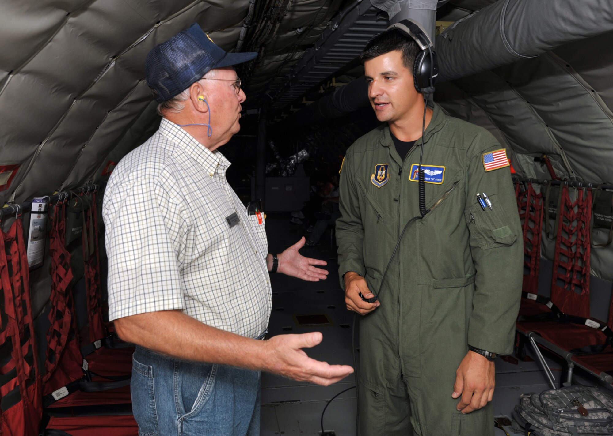Senior Airman James "J.D." Utash talks with Arthur Tannahill (on left) inside a KC-135 Stratotanker during an Honorary Commander Flight out of McConnell Air Force Base, Kan., in August. Airman Utash is a Reserve KC-135 boom operator assigned to the 18th Air Refueling Squadron, the flying unit of the 931st Air Refueling Group. Mr. Tannahill is the honorary commander of the 22nd Maintenance Squadron at McConnell. (U.S. Air Force photo/Tech. Sgt. Jason Schaap)