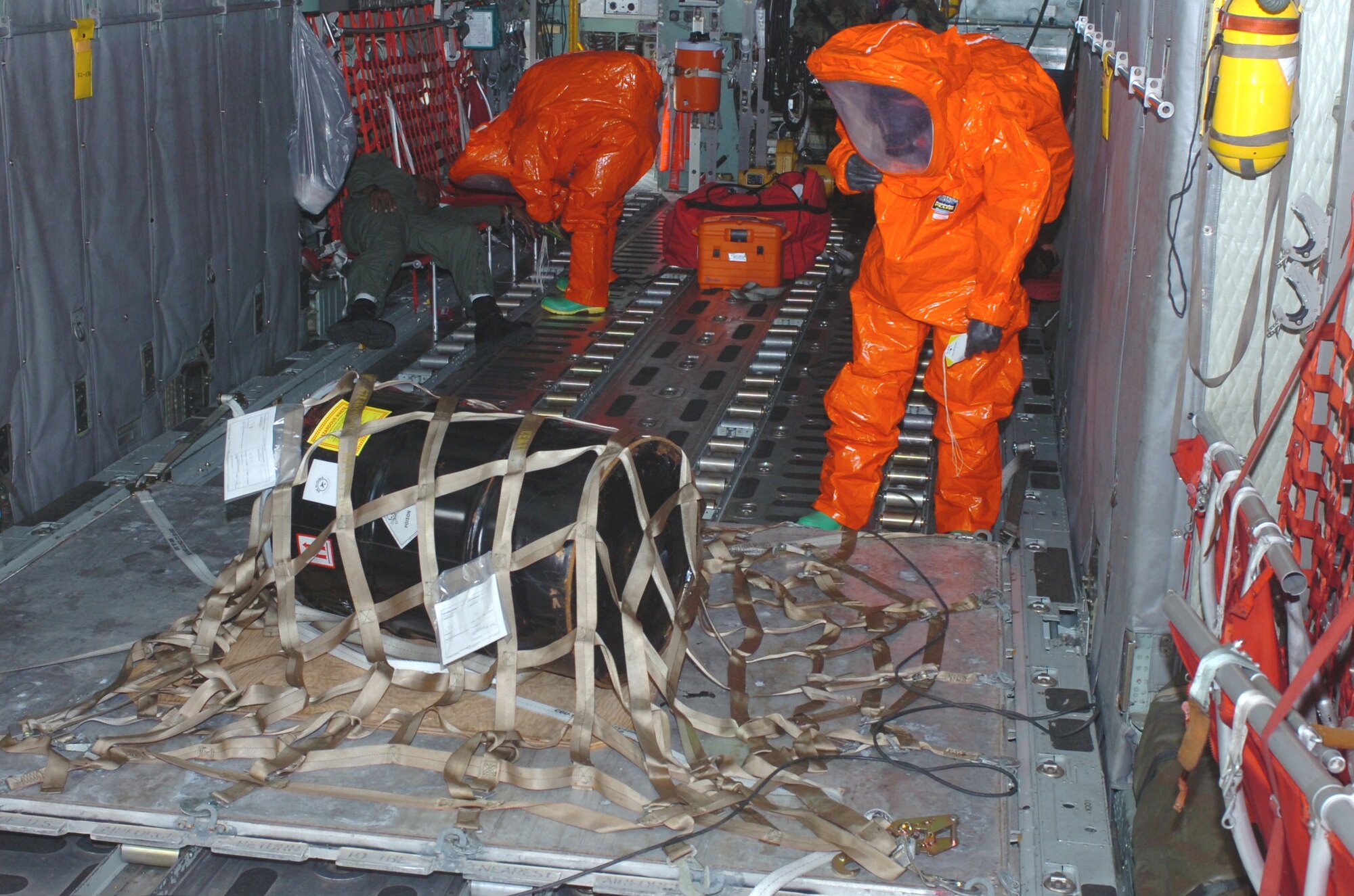 Walnut Ridge Firefighters in Level-1 HAZMAT suits assess the condition of crewmembers and the amount of a caustic chemical spilled from an overturned drum aboard an Air National Guard C-130 during an exercise held on Tuesday, September 1, 2009.  The joint exercise with the Air National Guard and local emergency responders tested coordination, communications and procedures for an aircraft incident at the Walnut Ridge Airport.  The C-130 and crew were from the 189th Airlift Wing of the Arkansas Air National Guard based at Little Rock Air Force Base. (Photo by Maj. Keith Moore, public affairs officer for the Arkansas Air National Guard.) 