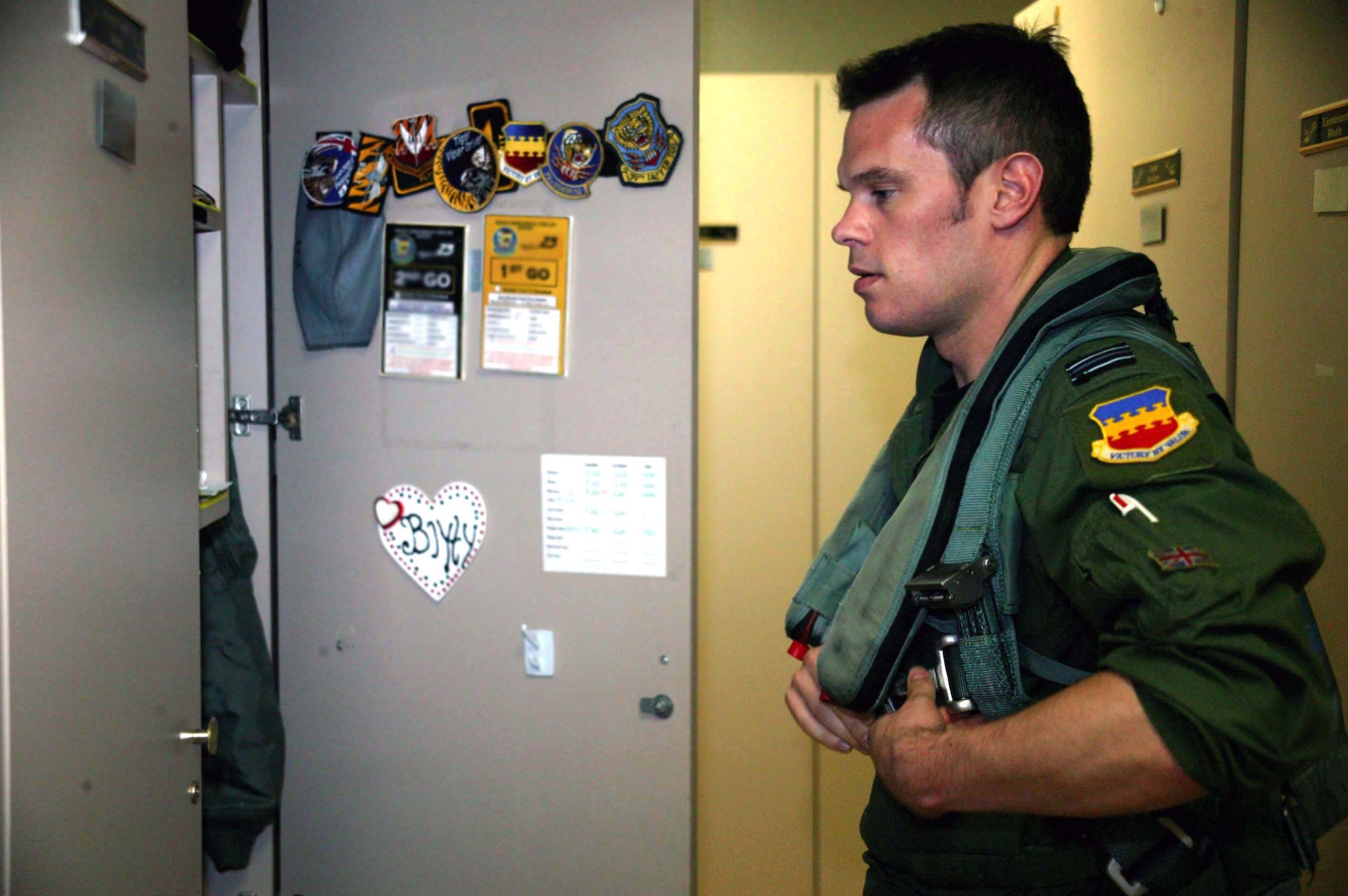 SHAW AIR FORCE BASE, S.C. -- Flight Lieutenant Andrew Mallery-Blythe, 79th Fighter Squadron F-16 pilot, dons his flight gear for a mission here Aug. 21. Leftenant Mallery-Blythe is an exchange pilot from the British Royal Air Force. The pilot exchange program trades fliers from different countries to learn how allies fly, train and fight. The purpose of the program is to improve international relations and pilot adaptability.(U.S. Air Force photo/Staff Sgt. John Gordinier)