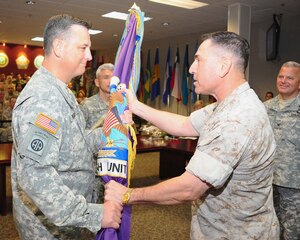 U.S. SOUTHERN COMMAND HEADQUARTERS, Miami — Army Col. Christopher Gehler recieves the Joint Task Force-Bravo guide-on for from Marine Corps Brig. Gen David Garza, chief of staff, U.S. Southern Command, during a change of command ceremony at the U.S. Southern Command Headquarters in Miami September 3. Joint Task Force-Bravo is one of three task forces under U.S. Southern Command. JTF-Bravo's primary mission is to provide command and control, administrative and logistical support for exercises, deployments and humanitarian and civic assistance projects conducted throughout Central America (Courtesy photo).