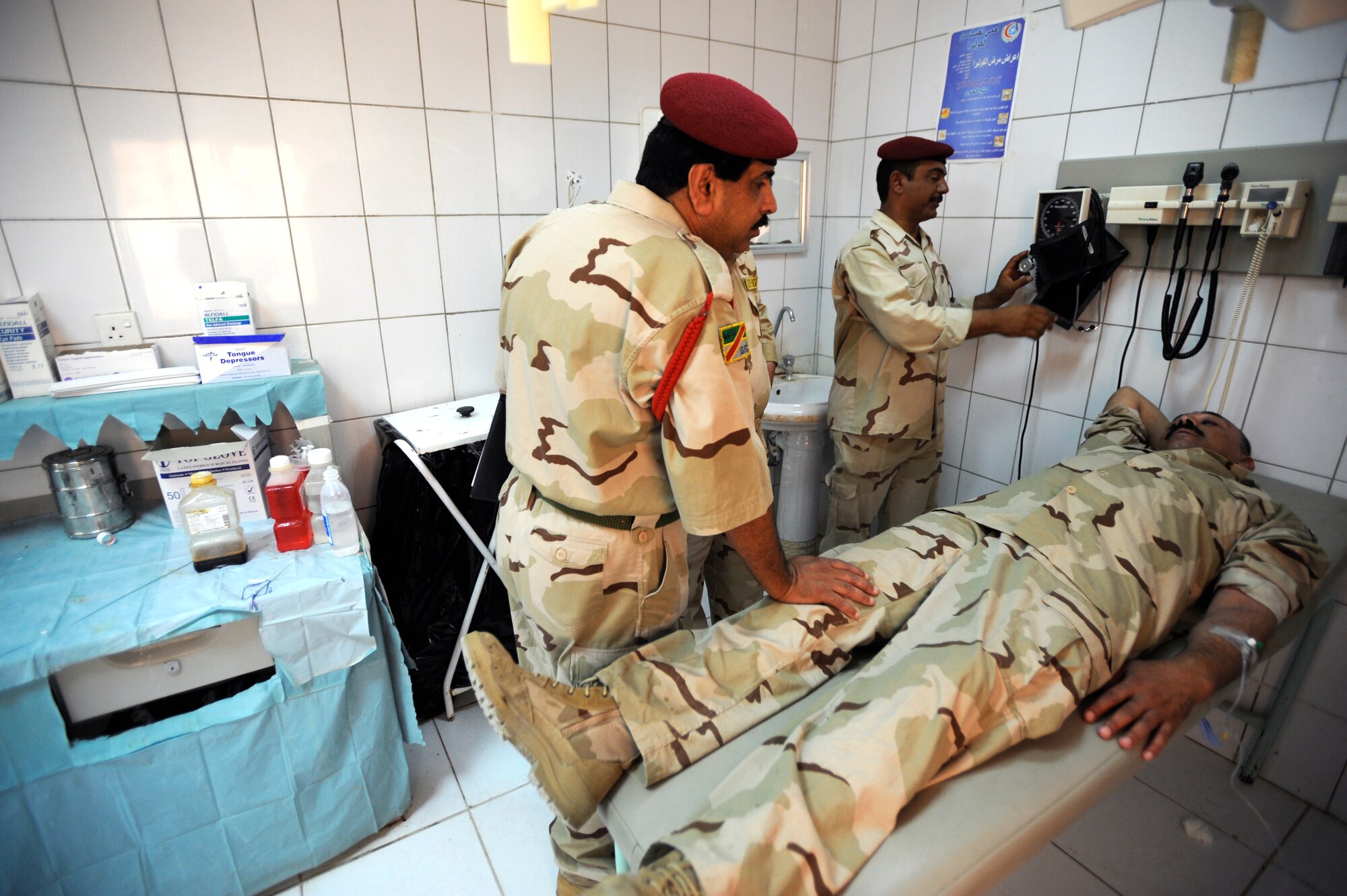 An Iraqi medical technician exams a fellow soldier in the clinic Aug. 17, 2009, at Camp Ur, Iraq. The Iraqi camp boasts a fully functioning medical clinic complete with a three-bay emergency room, pharmacy, dentist, radiology department and public health, as well as a highly trained team of doctors, nurses and technicians on staff. (U.S. Air Force photo/Staff Sgt. Shawn Weismiller) 