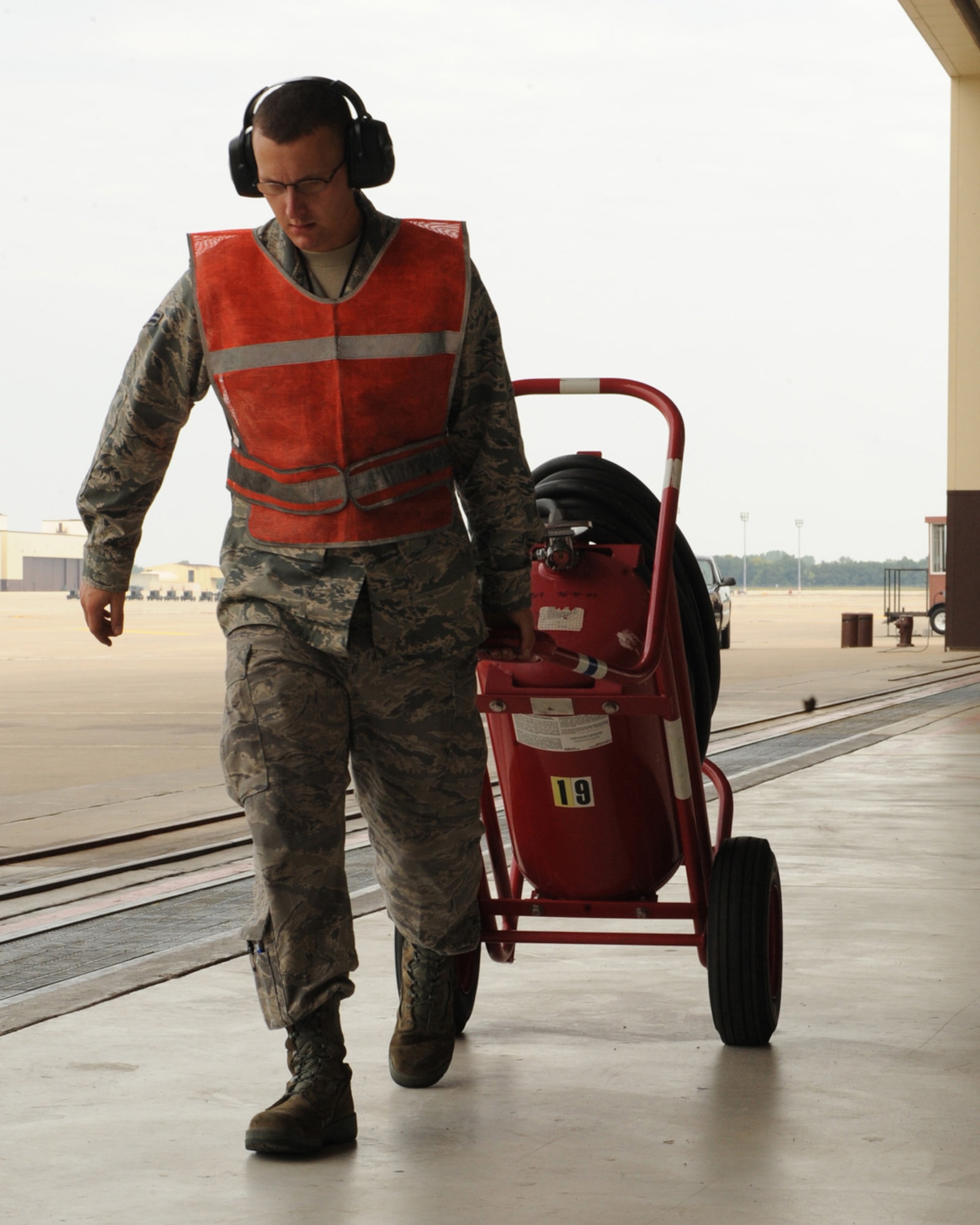 WHITEMAN AIR FORCE BASE, Mo. - Airman 1stClass Raymond Burgess, 509th Aircraft Maintenance Squadron, pulls the fire canister away from the front of the aircraft, getting prepared to taxi to launch, Sept. 3. (U.S. Air Force Photo by Airman 1st Class Carlin Leslie)