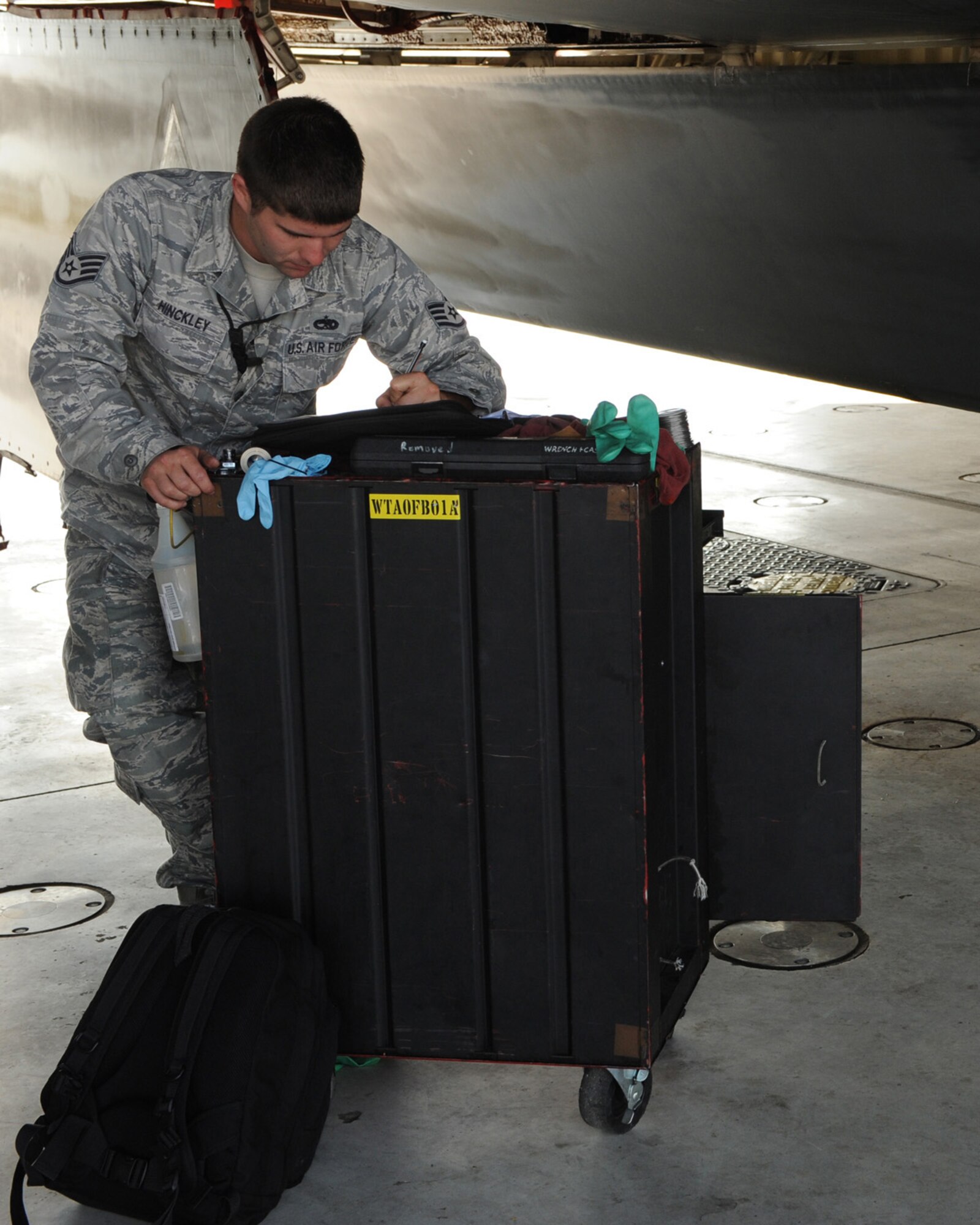 WHITEMAN AIR FORCE BASE, Mo. -  Staff Sgt. Eric Hinckley, 509th Aircraft Maintenance Squadron, completes paperwork on a filter element replacement, Sept. 3. The maintenance crew of this launch had to tackle this issue before the aircraft was allowed to launch. (U.S. Air Force Photo by Airman First Class Carlin Leslie)