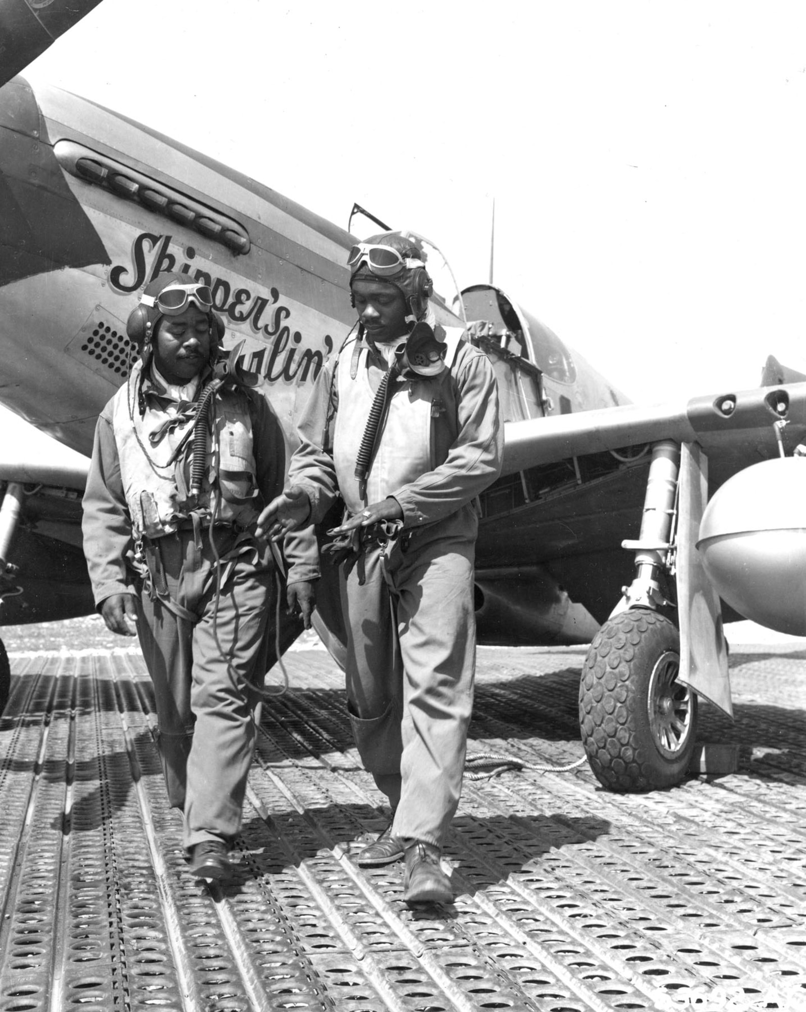 332nd Fighter Group pilots discuss combat flying. Their P-51 Mustangs, like the one here, were well-suited to long bomber escort missions. (U.S. Air Force photo)