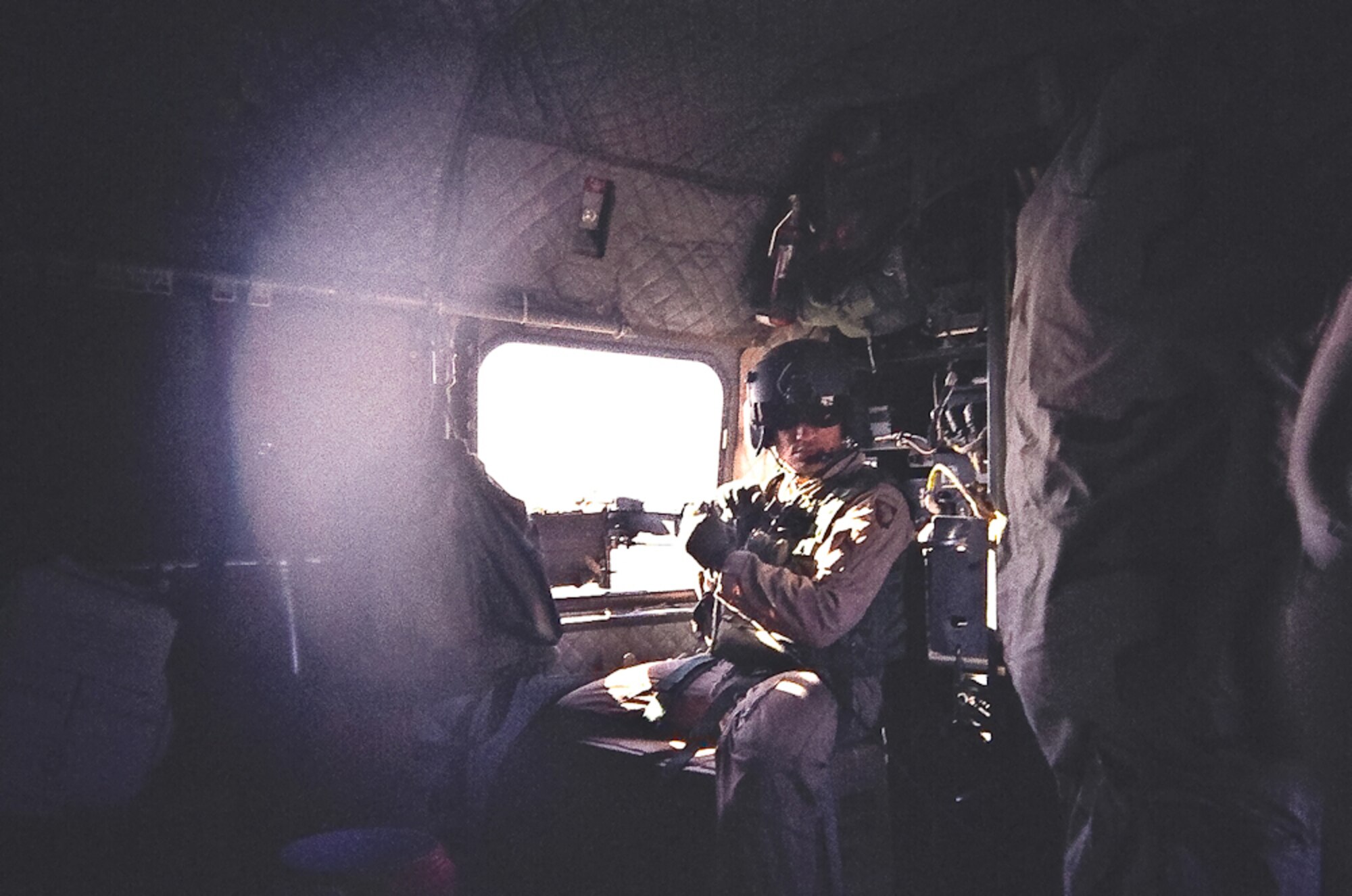 Army Specialist Jose Rosario-Ferrer sits in the gunner’s seat on board a CH-47 Chinook helicopter during a mission in Iraq in 2008. The crew was flying from Mosul and making a couple of stops on their way to Baghdad. (Photo provided)