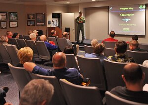 LANGLEY AIR FORCE BASE, Va. -- Lt. Col. Lance Pilch, 27th Fighter Squadron commander, discusses the capabilities of the F-22A Raptor during the 1st Fighter Wing Reunion Tour here Sept.3. The tour updated veterans on how the Air Force is changing and where it will be in the future. Veterans had a chance to visit their old squadrons and meet the new Airmen working there. (U.S. Air Force photo/Airman1st Class Jonathan Koob)