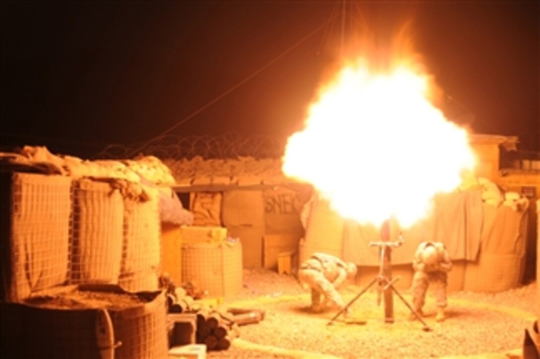 U.S. Army Spcs. Patrick Wilson (left) and Evaristo Garcia fire a 120 mm high-explosive mortar round during a coordinated illumination exercise at Forward Operating Base Mizan, Afghanistan, on Sept. 2, 2009.  Both soldiers are from Alpha Company, 1st Battalion, 4th Infantry Regiment, U.S. Army Europe.  