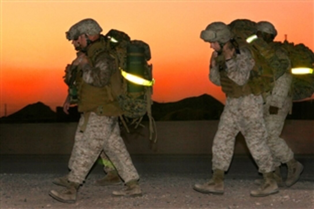 U.S. Marines and sailors participate in a six-mile hike on Camp Buehring, Kuwait, Sept. 2, 2009. The troops, assigned to the 22nd Marine Expeditionary Unit, joined three naval officers conducting the hike to meet a requirement to earn a Fleet Marine Force officer qualification pin.