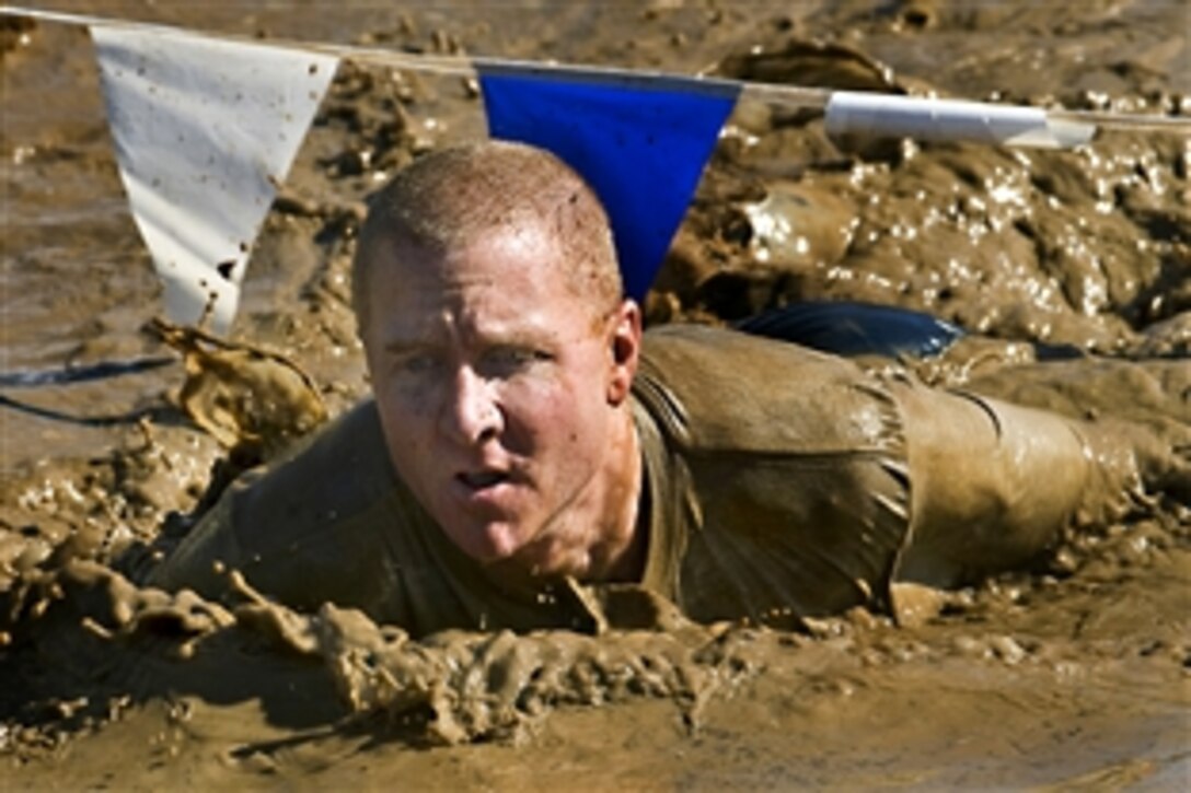 U.S. Air Force Master Sgt. Craig Brown crawls through the famed mud pit during the 10th Annual Mather Mud Run during Air Force Week Sacramento in Rancho Cordova, Calif., Sept. 5, 2009. The Mud Run features two obstacle courses with low walls, tunnel crawls, a tire run, hay bale jumps and a low-crawl mud pit. Brown is assigned to the 615th Contingency Response Wing on Travis Air Force Base, Calif.