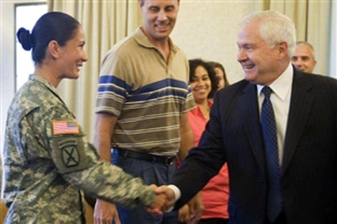 Defense Secretary Robert M. Gates shakes hands with Sgt. 1st Class Sumalee Bustamante at  George Washington Community Center on Fort Belvoir, Va., Sept. 8, 2009. Gates met privately with 14 soldiers and spouses to discuss various topics of concern for military families. Bustamante is a miitary policeman.