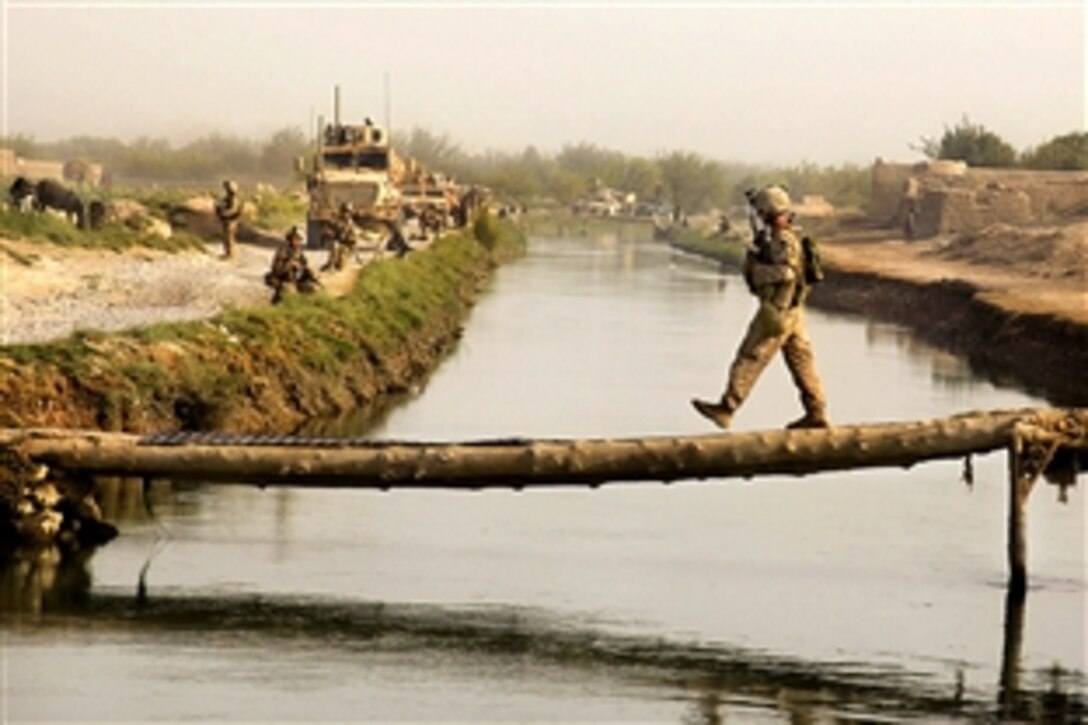 U.S. Marine Corps Sgt. Brian Kightlinger crosses a bridge during a security patrol in Helmand province's Nawa district, Afghanistan, Sept. 5, 2009. Kightlinger is assigned to Bravo Company, 1st Battalion, 5th Marine Regiment, and deployed with Regimental Combat Team 3, which conducts security patrols to decrease insurgent activity and gain the trust of the Afghan people.