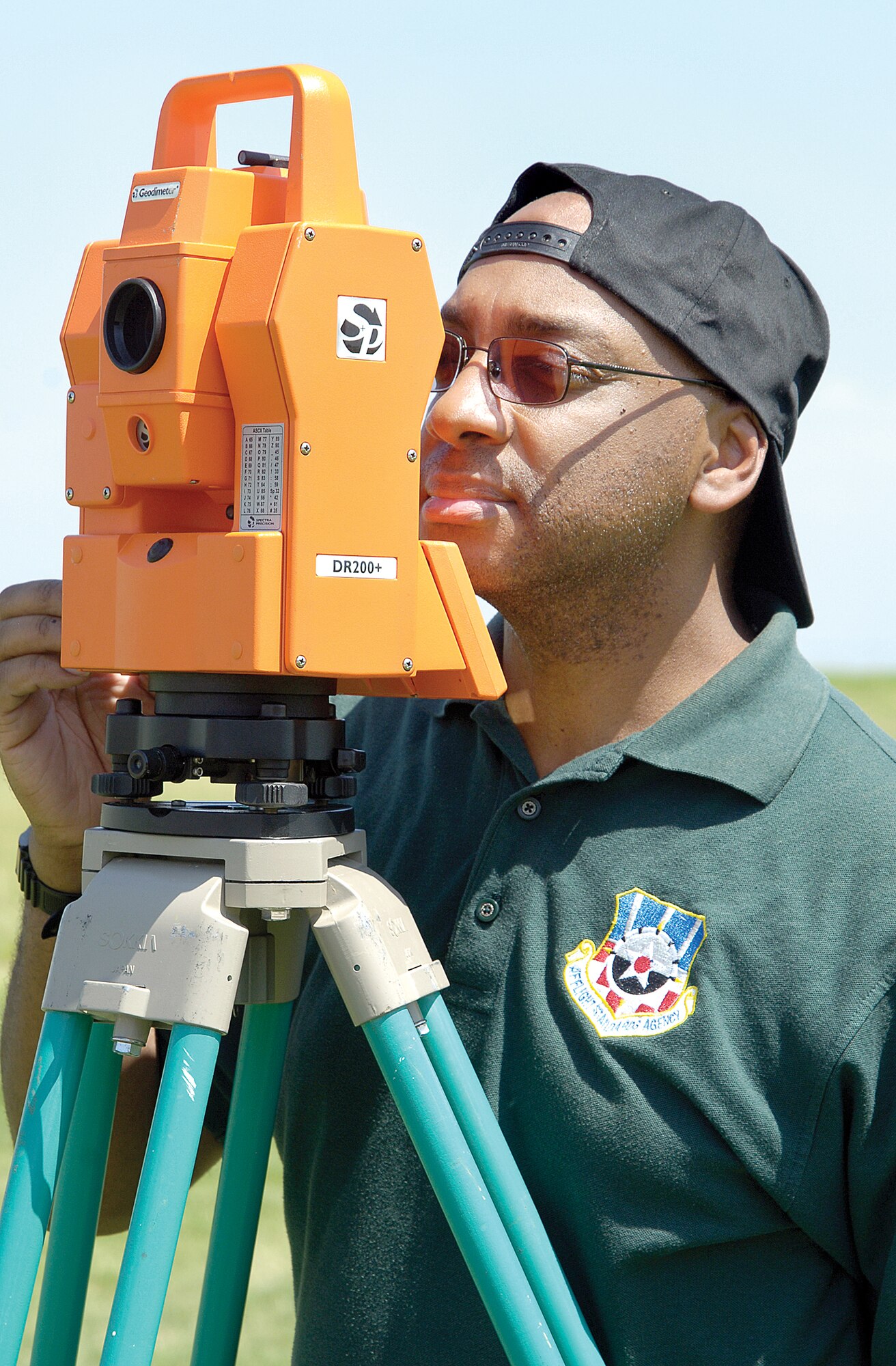 Dwight Bell takes a reading Aug. 31, 2009, during an airfield site inspection.  Mr. Bell is a geodesist with the Air Traffic Control and Landing Systems Evaluation Division of the Air Force Flight Standards Agency in Oklahoma City.  He has traveled the globe surveying and measuring bare base sites and established areas identifying any obstacles that would interfere with or degrade communication or air traffic control systems' radar signals. (U.S. Air Force photo/Margo Wright)