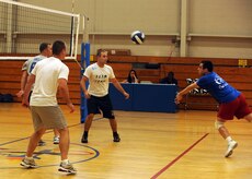 Steffan Fritz attempts to make a save while fellow 437th Communications Squadron team members wait to assist during an intramural volleyball match at the Fitness and Sports Center here Sept. 8. The 437th Medical Group team beat the 437 CS 25-21, and 25-12. Fritz is with the 437 CS. (U.S. Air Force photo/Senior Airman Katie Gieratz)