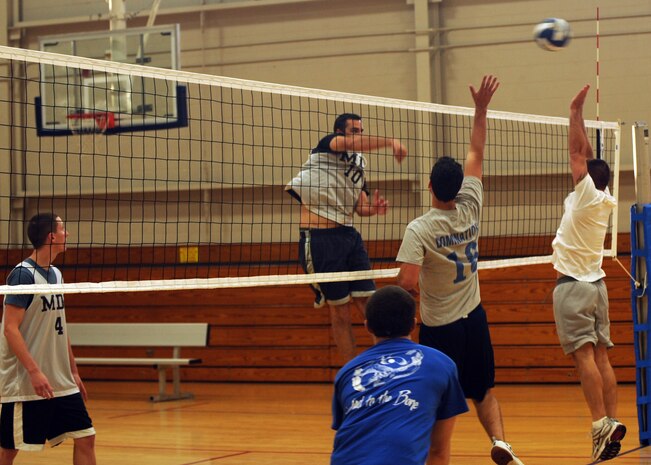Justin Steidler spikes the ball while Steve Wisecarver attempts to block it during an intramural volleyball match at the Fitness and Sports Center here Sept. 8. The volleyball season kicked off on Aug. 25 and will end Oct. 13. Steidler is with the 437th Medical Group and Wisecarver is with the 437th Communications Squadron. (U.S. Air Force photo/Senior Airman Katie Gieratz)