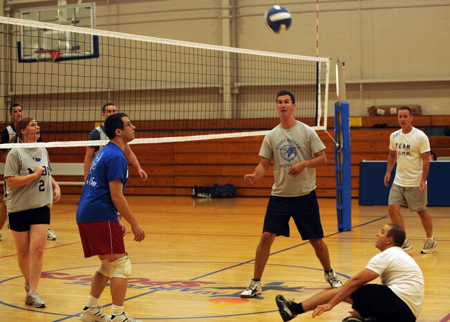 Riley Cusson slides to save the ball during an intramural volleyball match at the Fitness and Sports Center here Sept. 8. The volleyball season kicked off on Aug. 25 and will end Oct. 13. Cusson is with the 437th Communications Squadron. (U.S. Air Force photo/Senior Airman Katie Gieratz) 