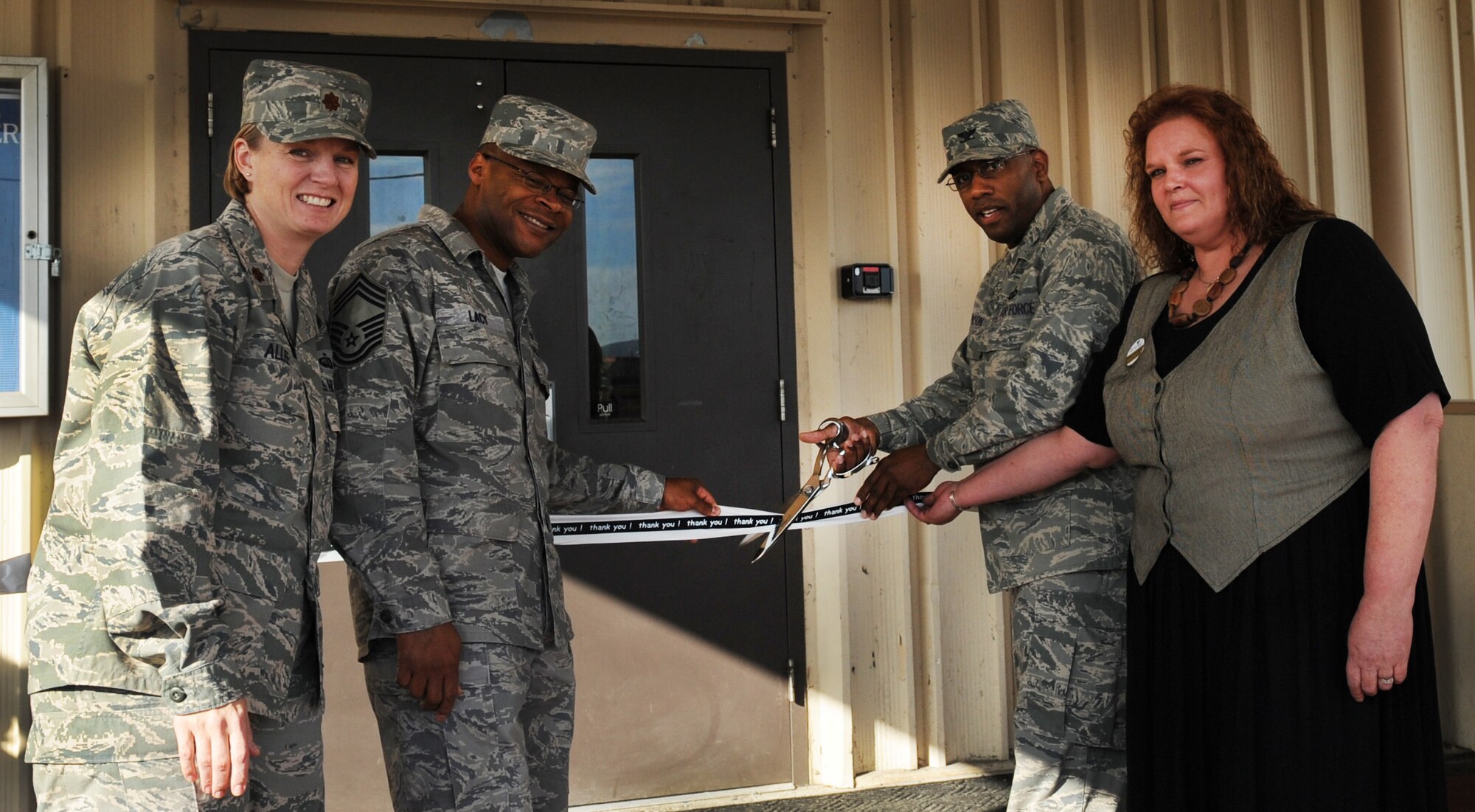 Maj. Jennifer Allee, Chief Master Sgt. Willard Lacy, Col. Karlton Johnson, and facility manager Debra Rodriquez cut the ribbon to the Arctic Nite Bowling Center during a reopening ceremony Sept. 2, 2009, Eielson Air Force Base, Alaska. A three week renovation included new carpet and tile throughout the facility, a new lighting and sound system, and a self-help countertop replacement project. Colonel Johnson is the 354th Mission Support Group commander. (U.S. Air Force photo/Airman 1st Class Laura Goodgame)