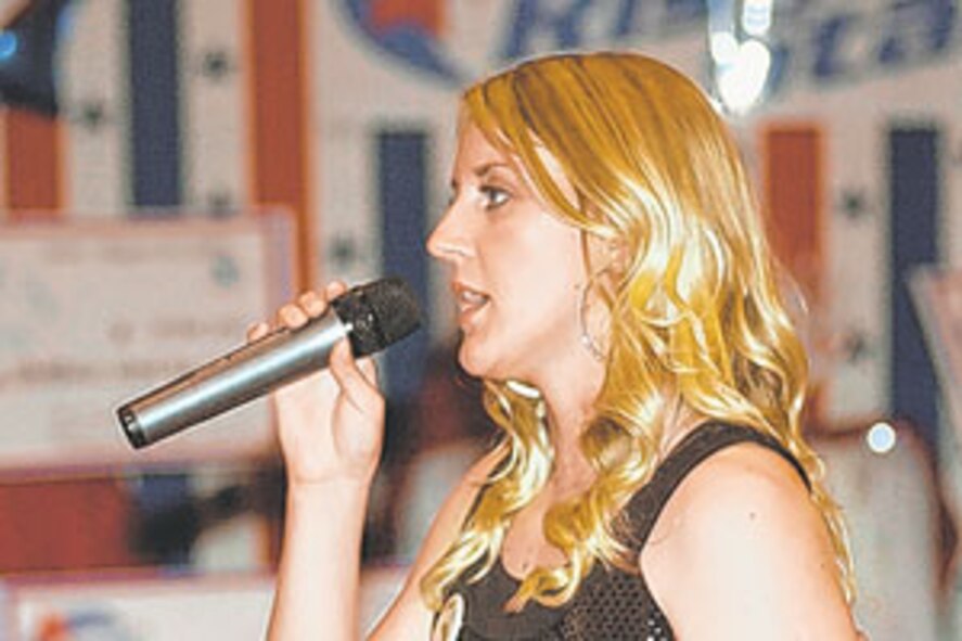 Airman Jamie Jarman sings during the first round of the Operation Rising Star finals, Aug. 25, at Pershing Community Center. Jarman took first place. (U.S. Army photo/Matt Decker) 