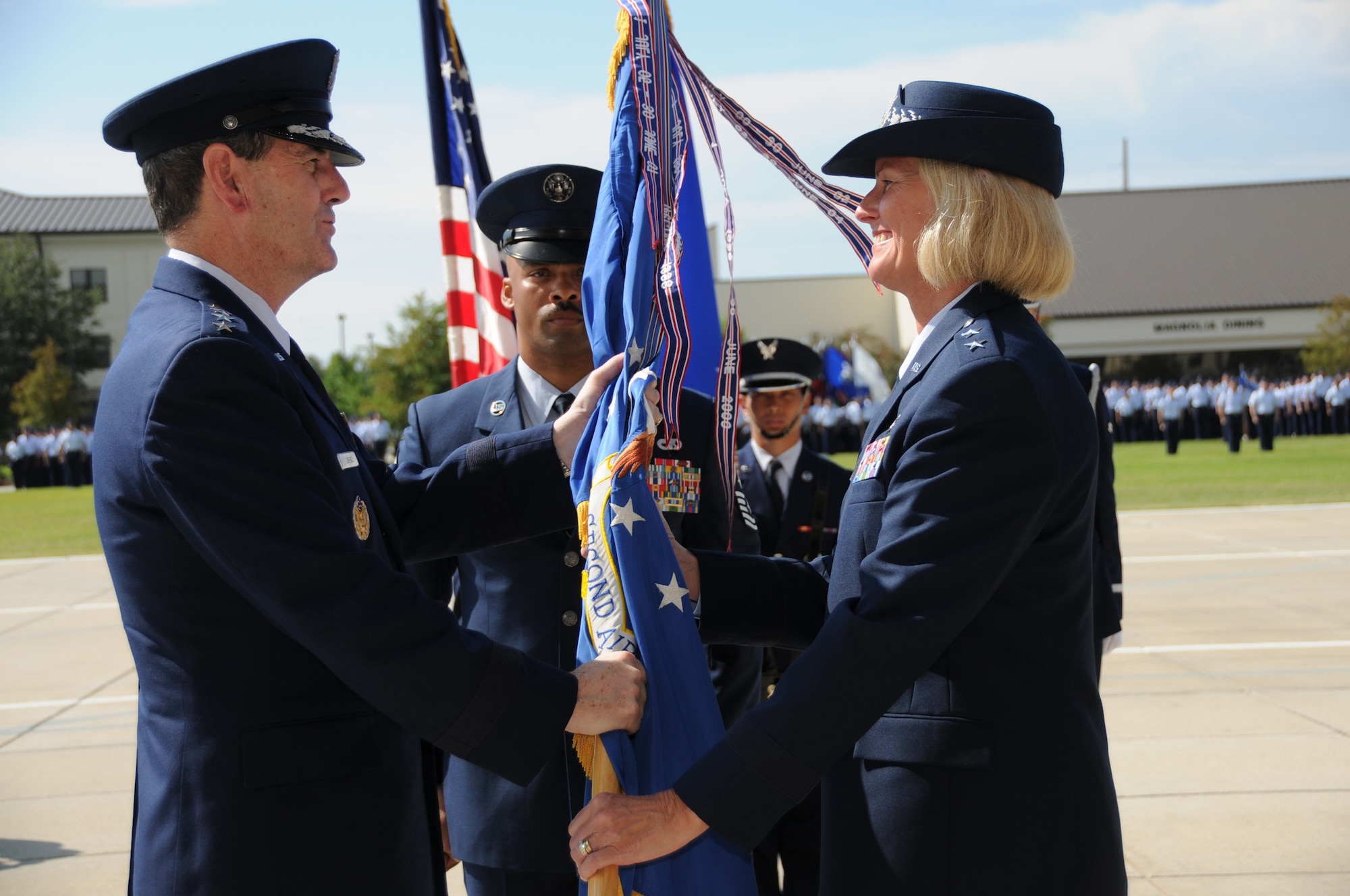 Gen. Stephen R. Lorenz, commander of Air Education and Training Command, hands the 2nd Air Force flag to Maj. Gen. Mary Kay Hertog during a change the 2nd Air Force change of command ceremony here Sept. 9. General Hertog took command of 2nd Air Force from Maj. Gen. Alfred Flowers at the Levitow Parade Field.  (U.S. Air Force photo by Kemberly Groue)