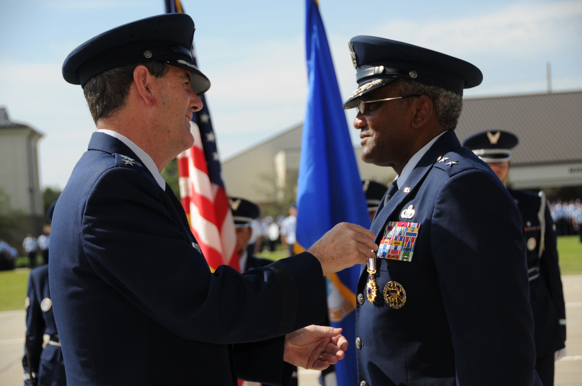 Brig. Gen. Ian Dickinson pins the Distinguished Service Medal on Maj. Gen. Alfred Flowers during the 2nd Air Force change of command here Sept. 9. Maj. Gen. Mary Kay Hertog took command of 2nd Air Force from General Flowers at the Levitow Parade Field.  (U.S. Air Force photo by Kemberly Groue)
