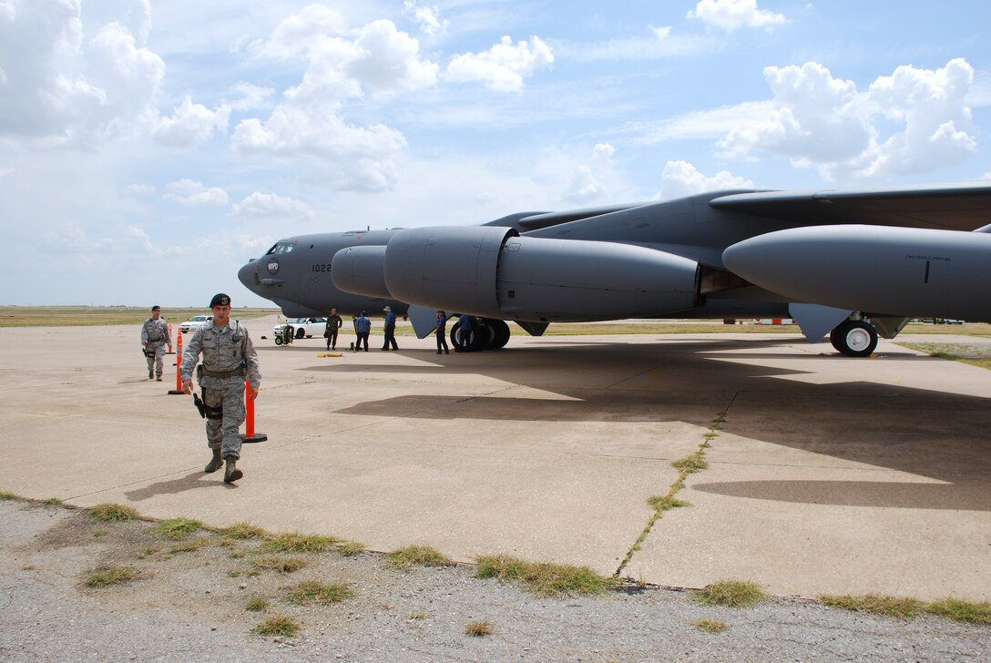 Airman 1st Class Nicholas Carmen, front, and Staff Sgt. Robert Ragland of the 82nd Security Forces Squadron work on setting up a perimeter Sept. 9 around a B-52H Stratofortress. The aircraft landed at Sheppard Air Force Base to become part of the 82nd Training Wing's fleet of ground instructional training aircraft. This specific B-52H Stratofortres was part of the first strike force to respond to the events of Sept. 11, 2001. (U.S. Air Force photo/John Ingle)