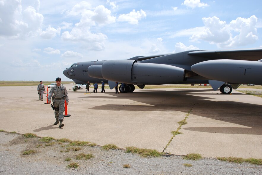Airman 1st Class Nicholas Carmen, front, and Staff Sgt. Robert Ragland of the 82nd Security Forces Squadron work on setting up a perimeter Sept. 9 around a B-52H Stratofortress. The aircraft landed at Sheppard Air Force Base to become part of the 82nd Training Wing's fleet of ground instructional training aircraft. This specific B-52H Stratofortres was part of the first strike force to respond to the events of Sept. 11, 2001. (U.S. Air Force photo/John Ingle)