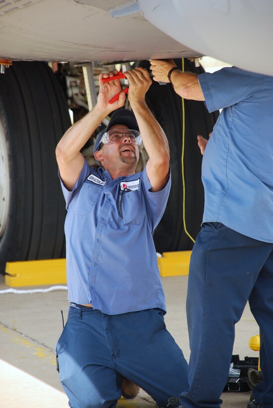 Wayne Bradbury, a machinist with L3 Communications at Sheppard Air Force Base, secures a hatch Sept. 9 on a B-52H Stratofortress after it landed to become a new ground instructional trainer for the 82nd Training Wing. The B-52H, was part of the first strike force to respond to the events of Sept. 11, 2001. The aircraft has nose art in memory of the event and those who lost their lives. (U.S. Air Force photo/John Ingle)