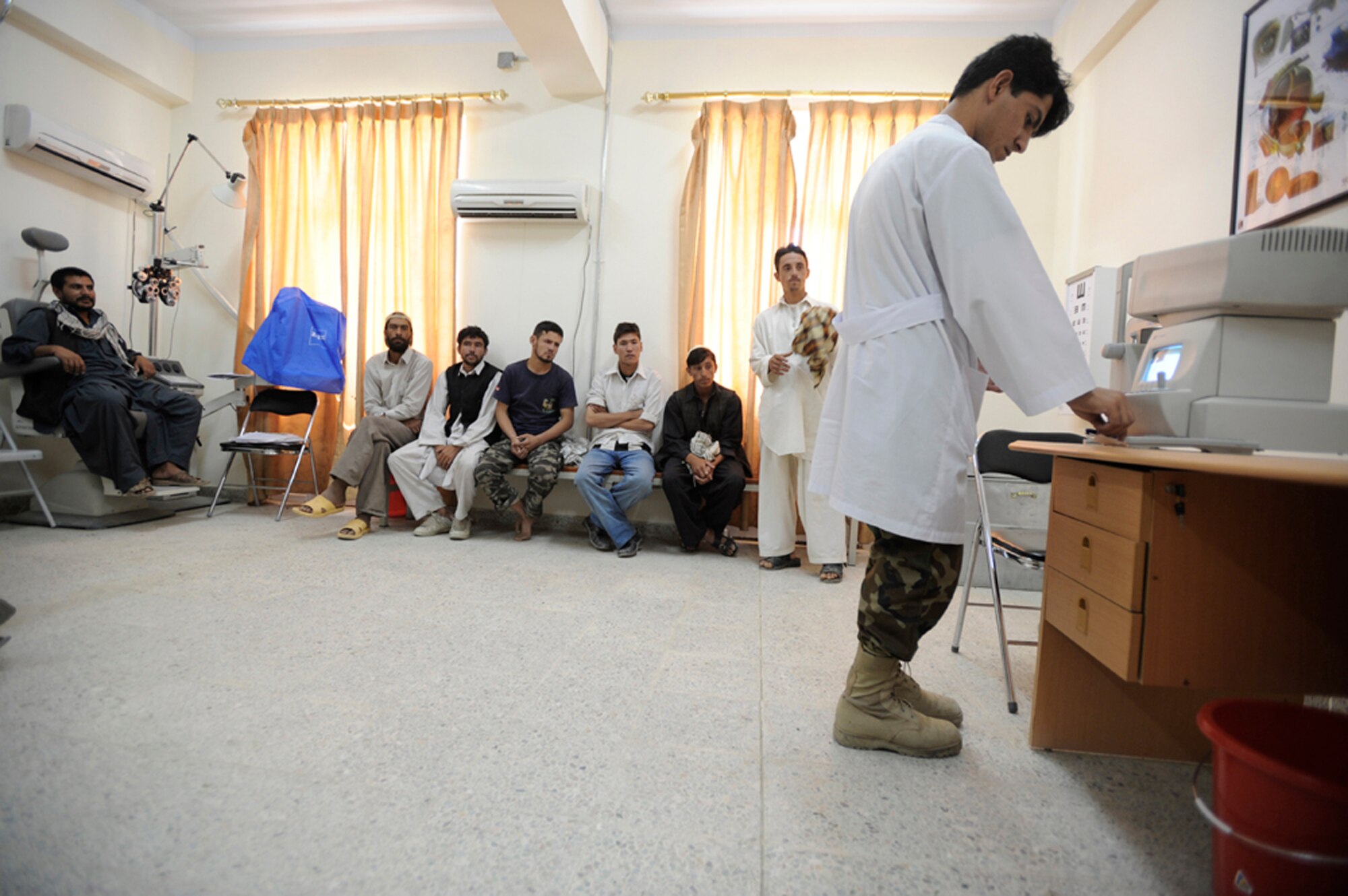 Recruits for the Afghan national army wait to have their vision screened during medical inprocessing Aug 2, 2009 at the Kabul military training center, Afghanistan. The medical screening process consists of a drug urinalysis, physical screening and eye exam. (U.S. Air Force photo/Staff Sgt. Shawn Weismiller) 