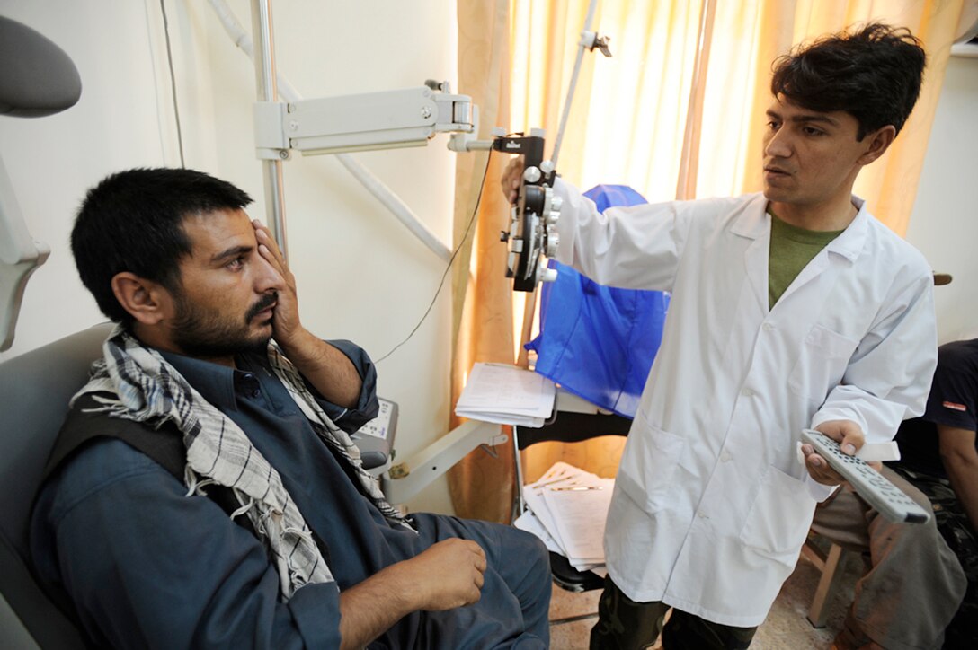 A recruit for the Afghan national army has his vision screened during medical inprocessing Aug 2,2009 at the Kabul Military Training Center in Afghanistan. The medical screening process consists of a drug urinalysis, physical screening and eye exam. (U.S. Air Force photo/Staff Sgt. Shawn Weismiller) 