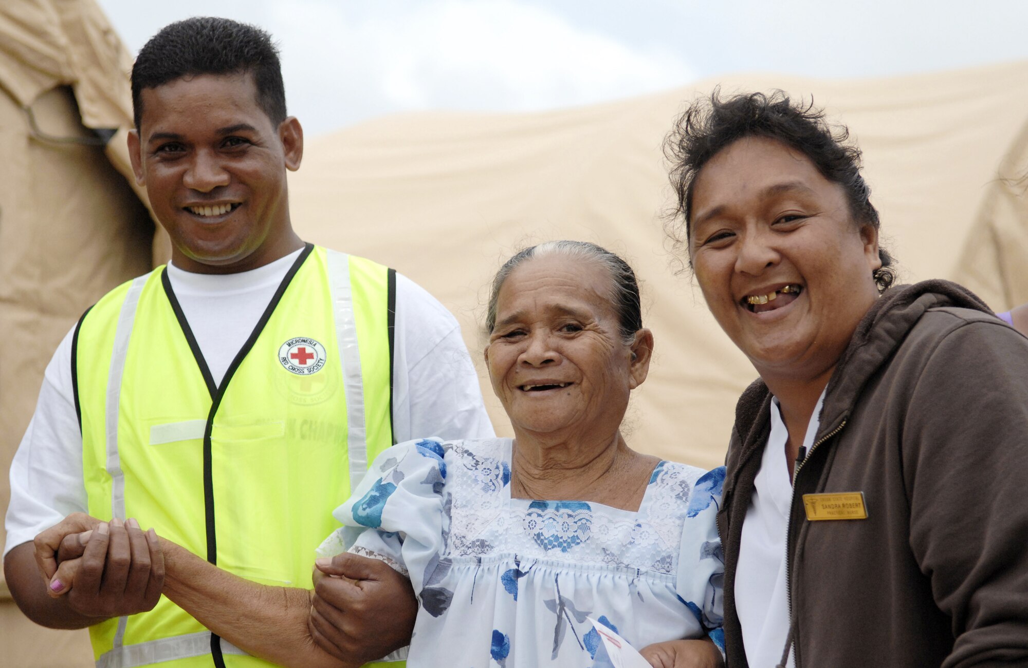 A Chuukese woman is escorted by two volunteers after receiving treatment from the humanitarian assistance rapid response team during a validation exercise Sept. 3, 2009, on Chuuk, in the Federated States of Micronesia. The team is the Air Force's new expeditionary medical capability designed to deploy within 24-hours of notice during disaster relief operations.  Based at Andersen Air Force Base, Guam, the team provides basic medical care and public health assistance to 350-500 patients per day. (U.S. Air Force photo/Capt. Andrew Hoskinson)

