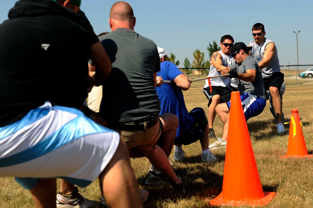 (Right) Members of the 28th Civil Engineer Squadron defeat members of the 28th Communications Squadron during the tug-of-war competition as part of the Ellsworth Base Picnic here, Sept. 3. The picnic had multiple sporting events including: volleyball, tug of war, dizzy bat racing and basketball. (U.S. Air Force photo by Airman 1st Class Corey Hook)