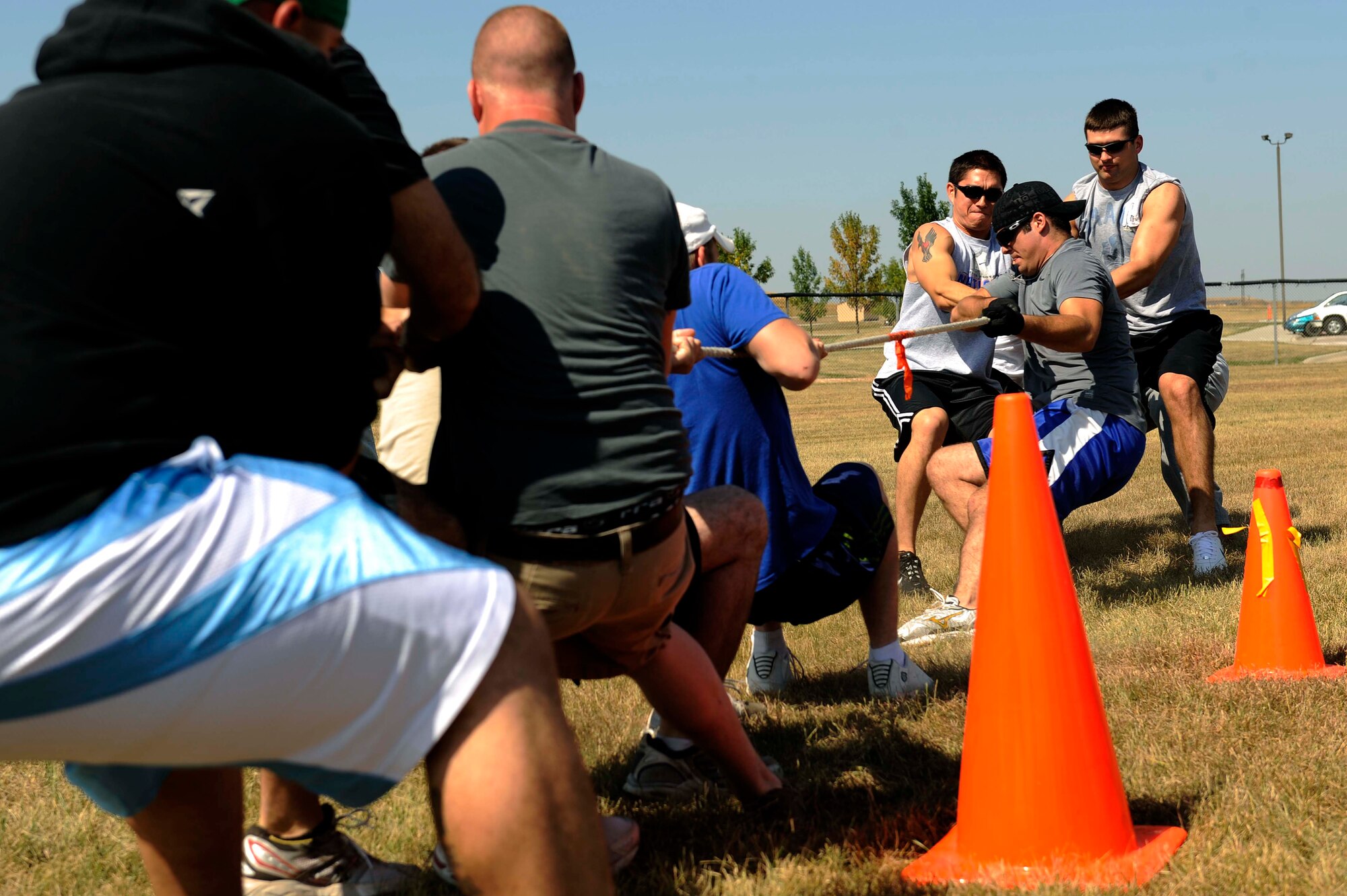 (Right) Members of the 28th Civil Engineer Squadron defeat members of the 28th Communications Squadron during the tug-of-war competition as part of the Ellsworth Base Picnic here, Sept. 3. The picnic had multiple sporting events including: volleyball, tug of war, dizzy bat racing and basketball. (U.S. Air Force photo by Airman 1st Class Corey Hook)