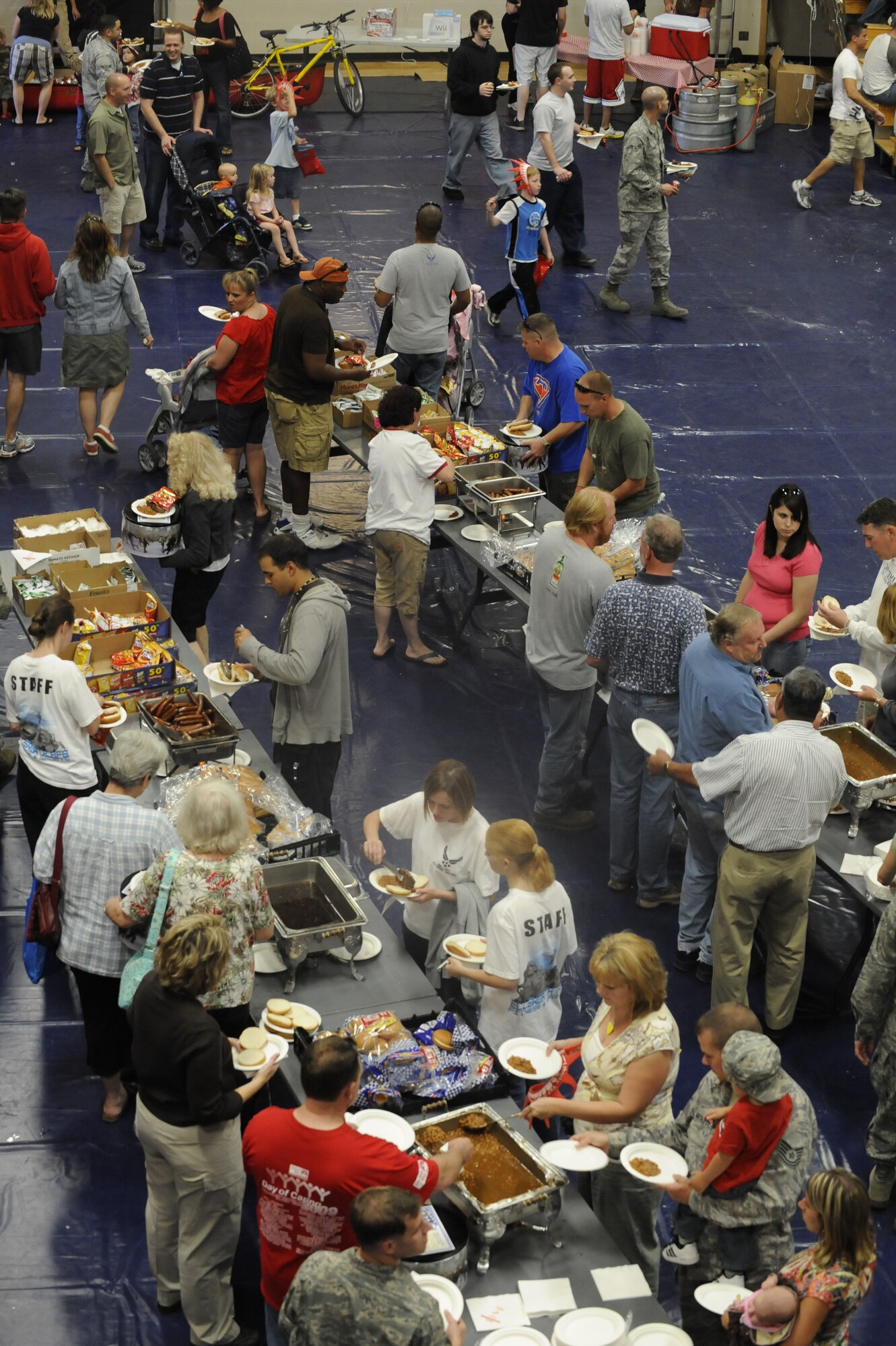 Ellsworth community members grab free food during the Ellsworth Base Picnic here, Sept. 3. Multiple base organizations sponsored the picnic by providing volunteers, equipment, and food. (U.S. Air Force photo by Airman 1st Class Corey Hook)